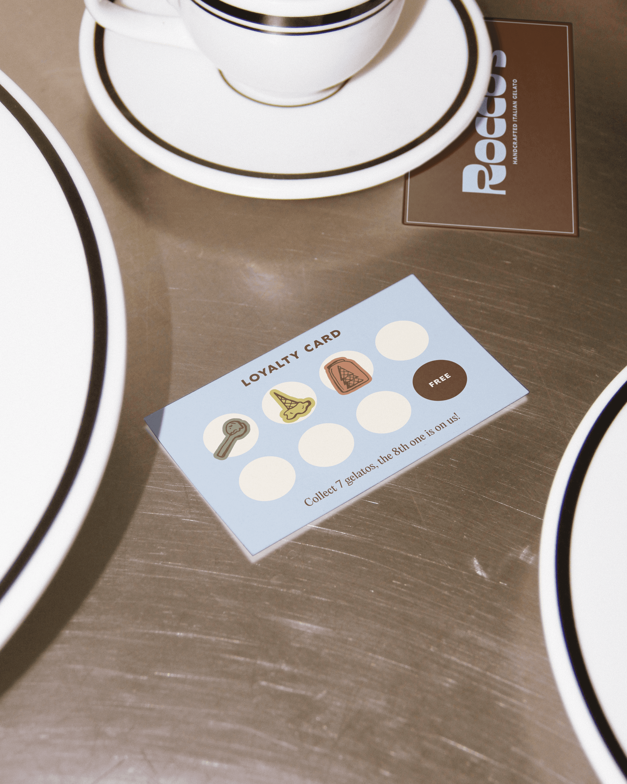 Paccos gelato loyalty card on a café table