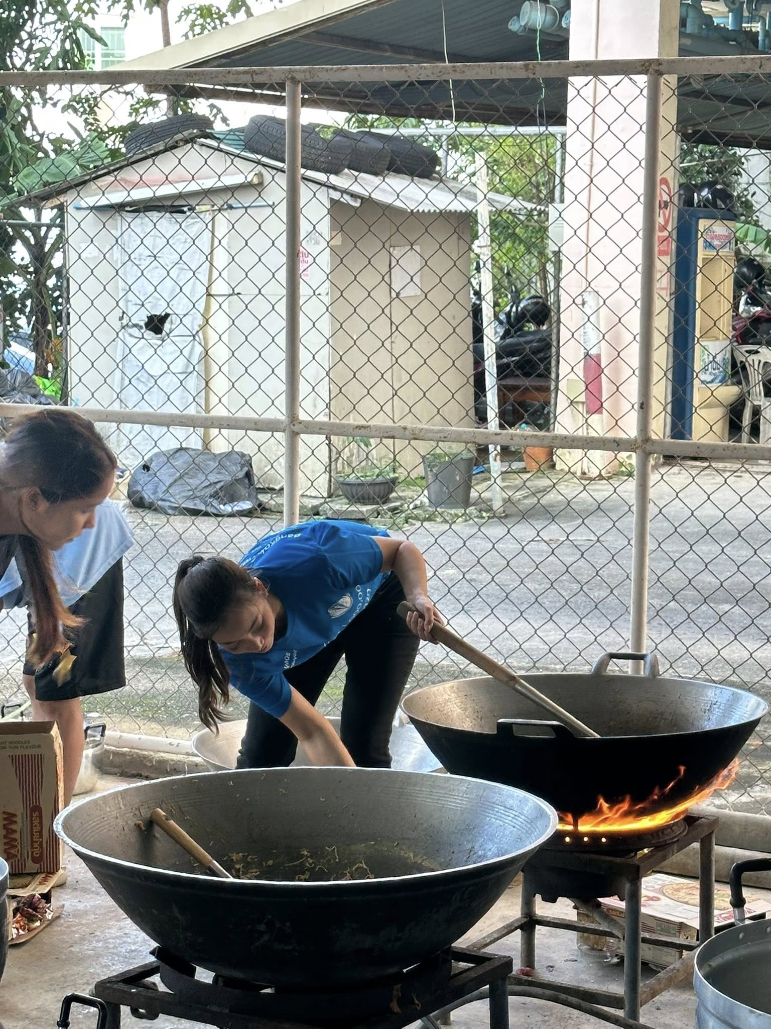 two young boys brushing their teeth in front of a crowd