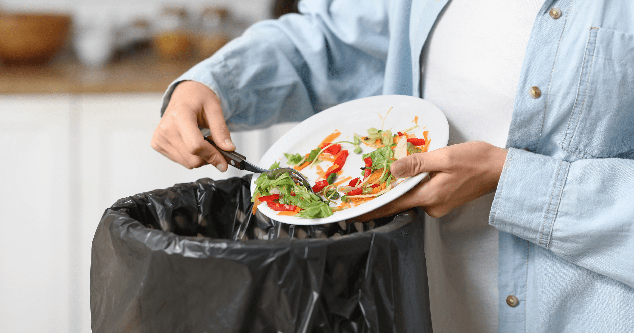 A woman throwing away leftover food