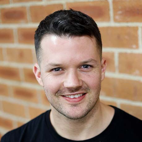 a woman in a black suit and sunglasses