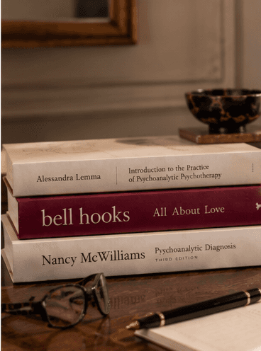 Books on psychoanalytic psychotherapy and relationships arranged on a desk