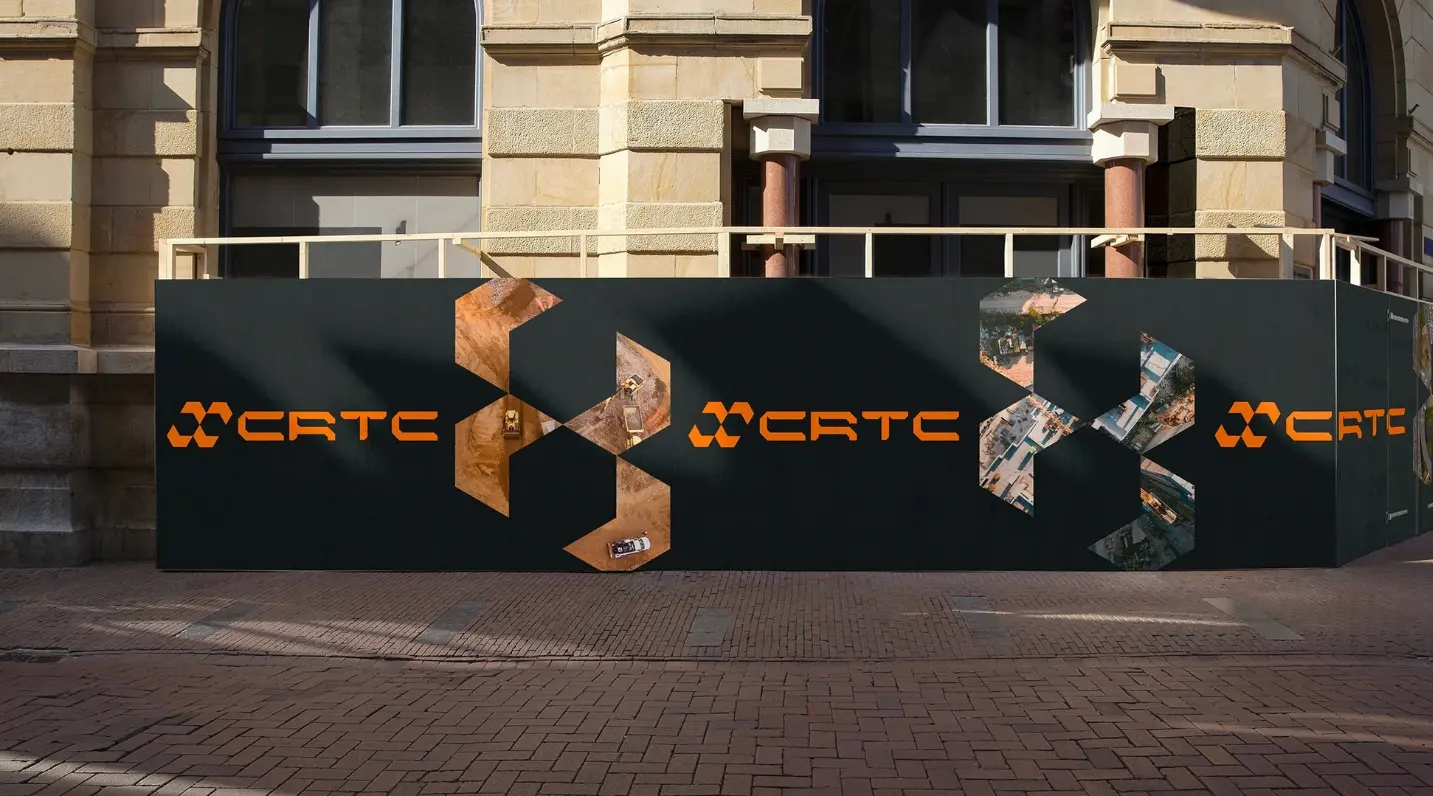 A large outdoor banner with the CTRC logo and geometric arrow graphics wraps a city building facade, featuring robotics branding and brand identity design elements.