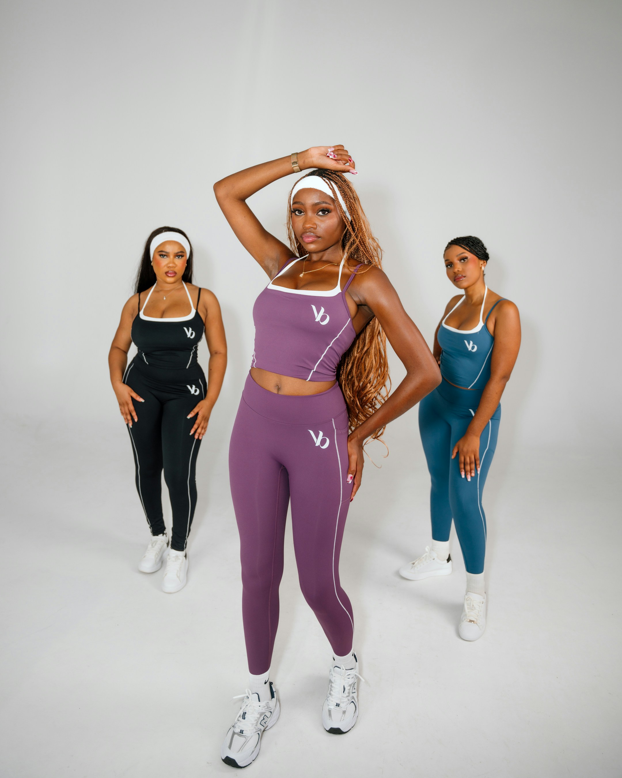 Three women in athletic wear posing