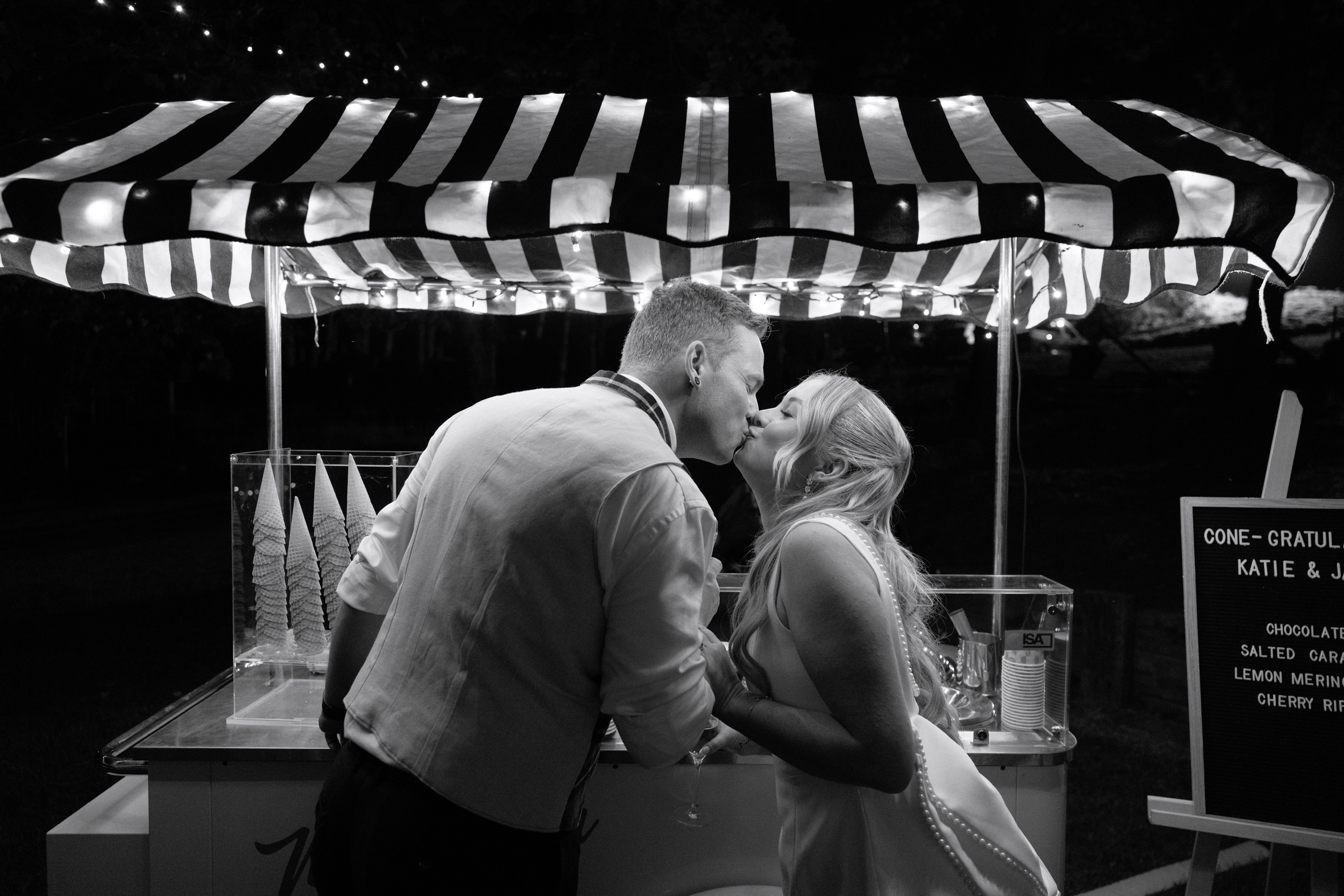 Couple kissing in front of gelato cart