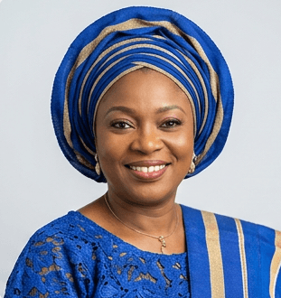 A young man with dark hair and a serious expression, wearing a white shirt against a neutral background.