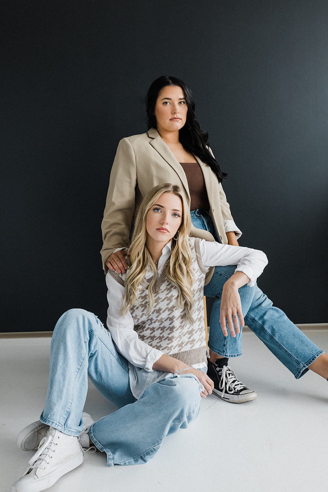 Professional photo of two women in front of a black backdrop