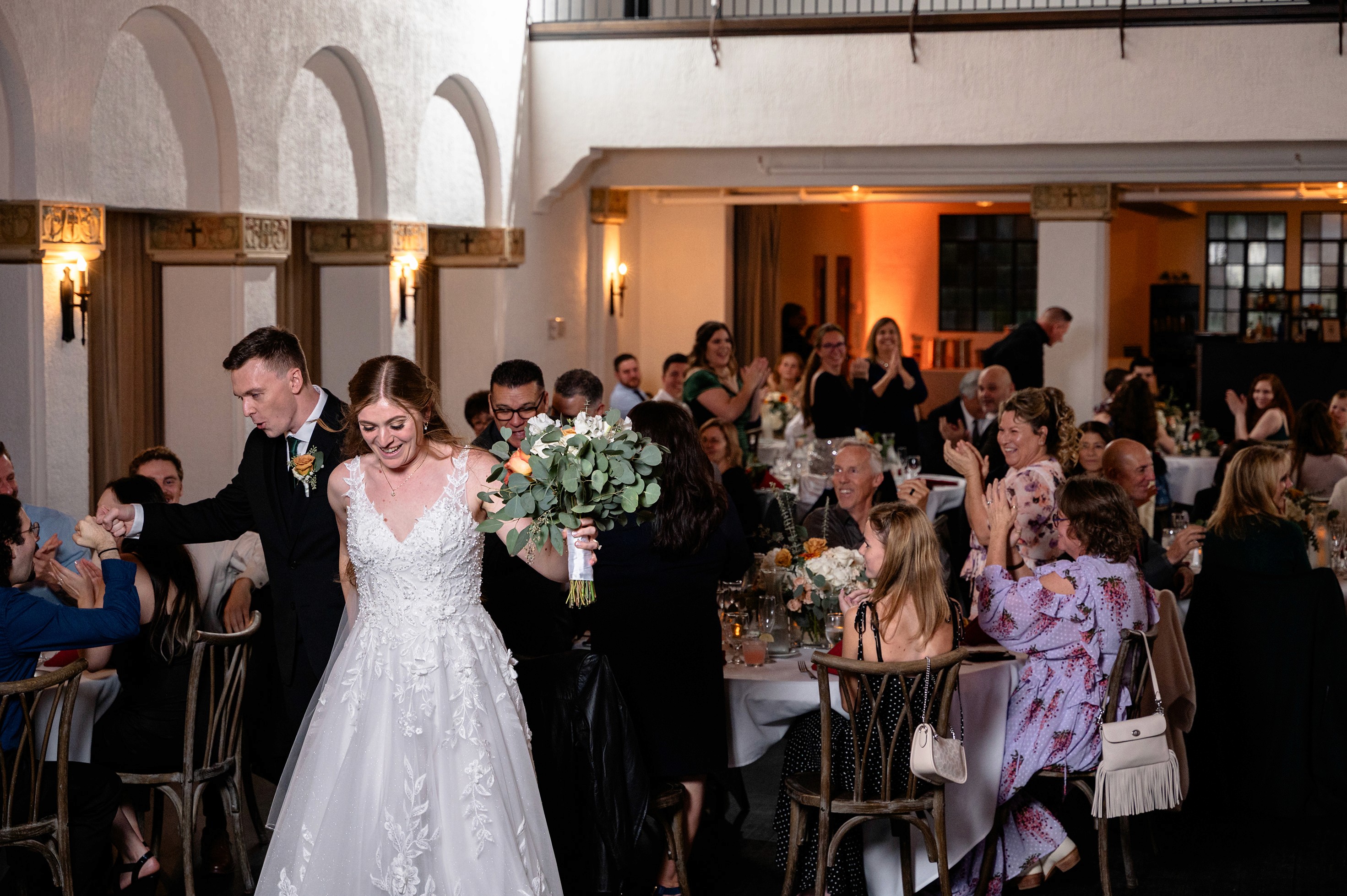 Flat lay wedding details with bouquet, rings, and sparkling bridal heels