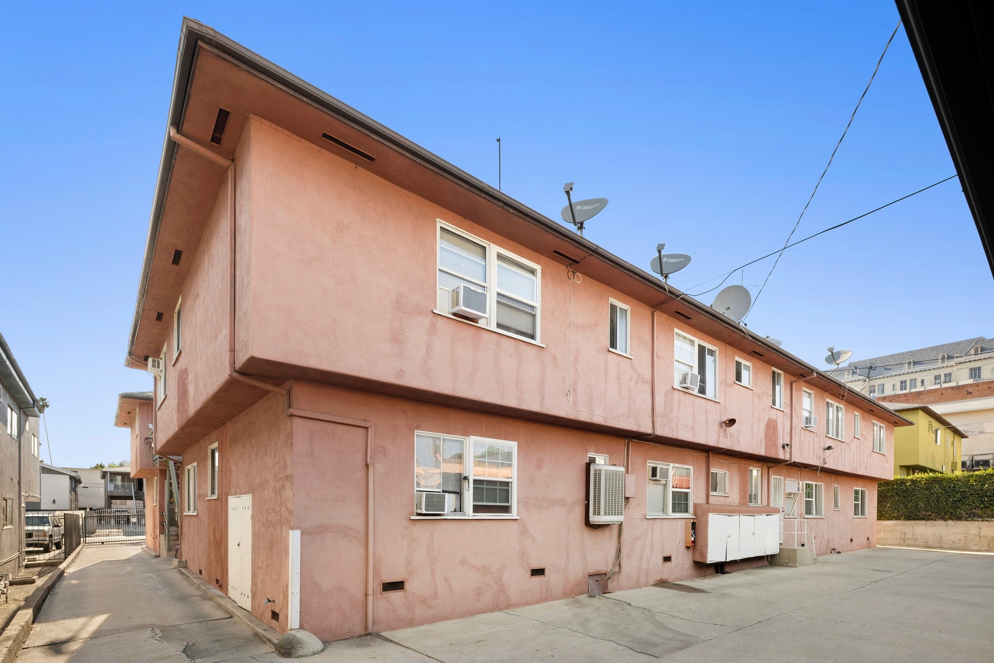 1640 N Harvard residential property corner view with peach facade, multiple windows, and street parking