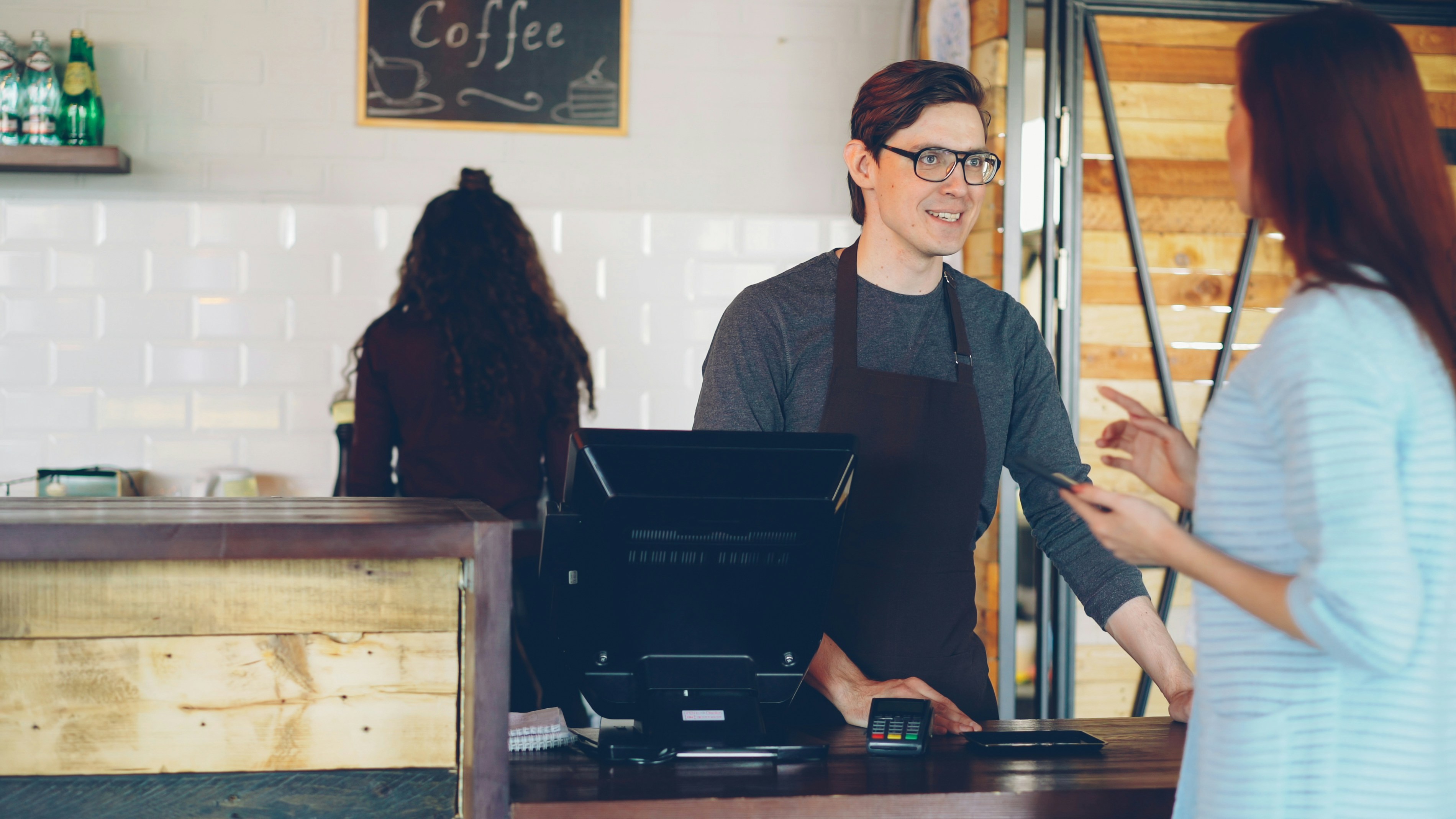 Customer pays at a coffee shop.