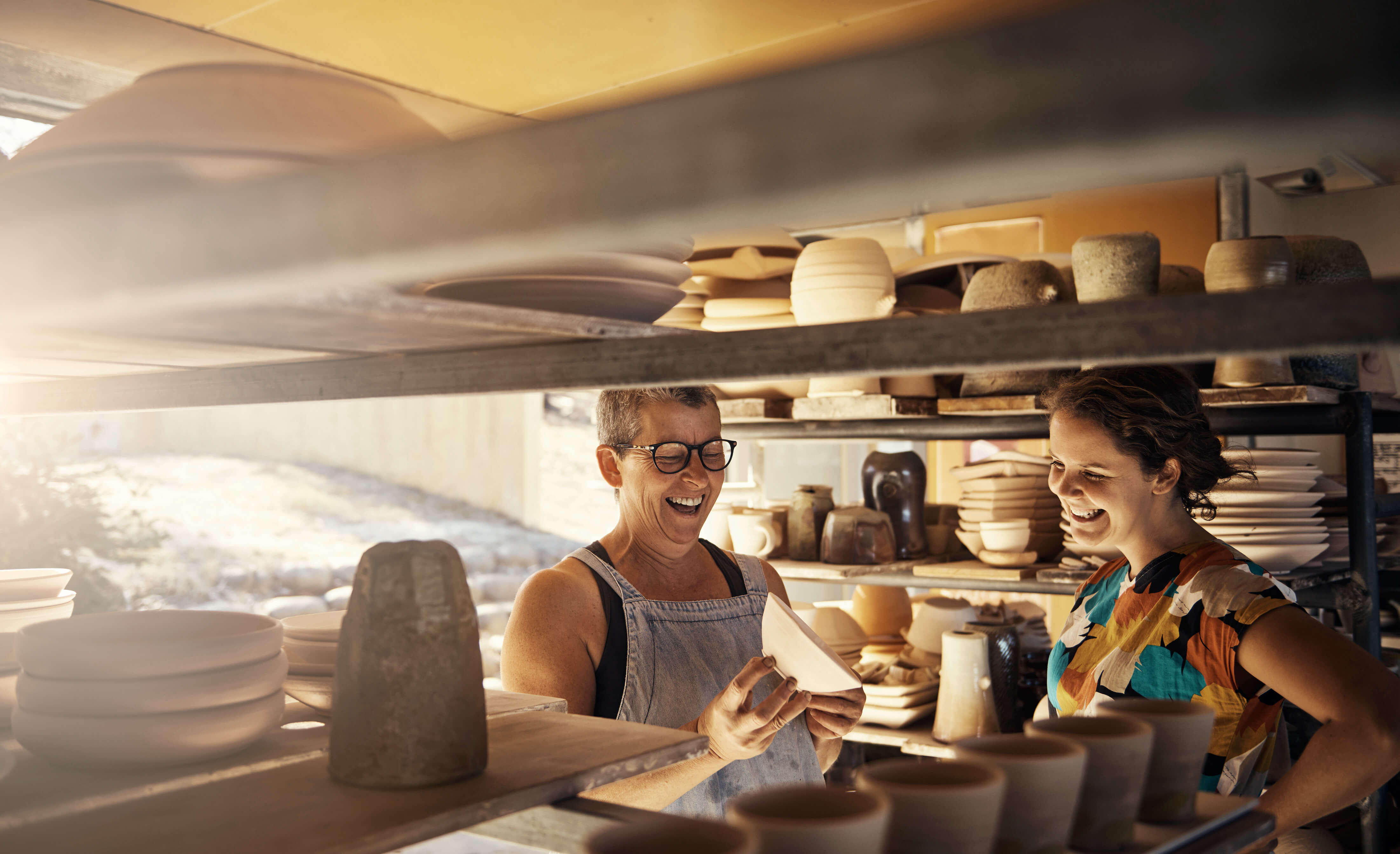 image of mother and adult daughter in ceramics studio