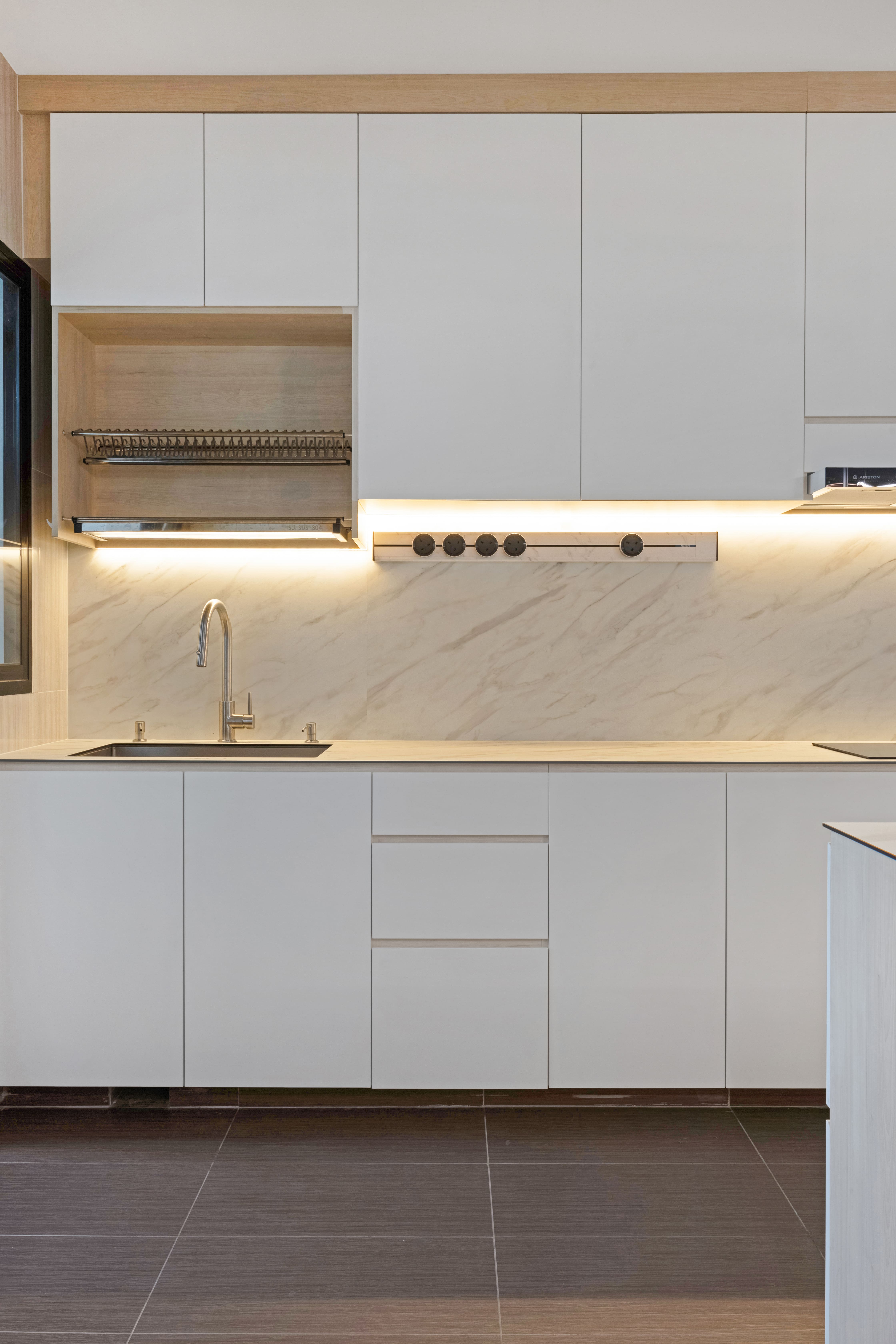 Full kitchen view showcasing clean lines, ample cabinetry, and under-lighting that pairs functionality with a refined modern look.