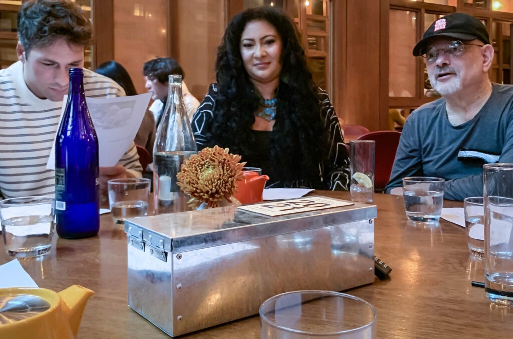 people sitting at table with Time Capsule box in the middle