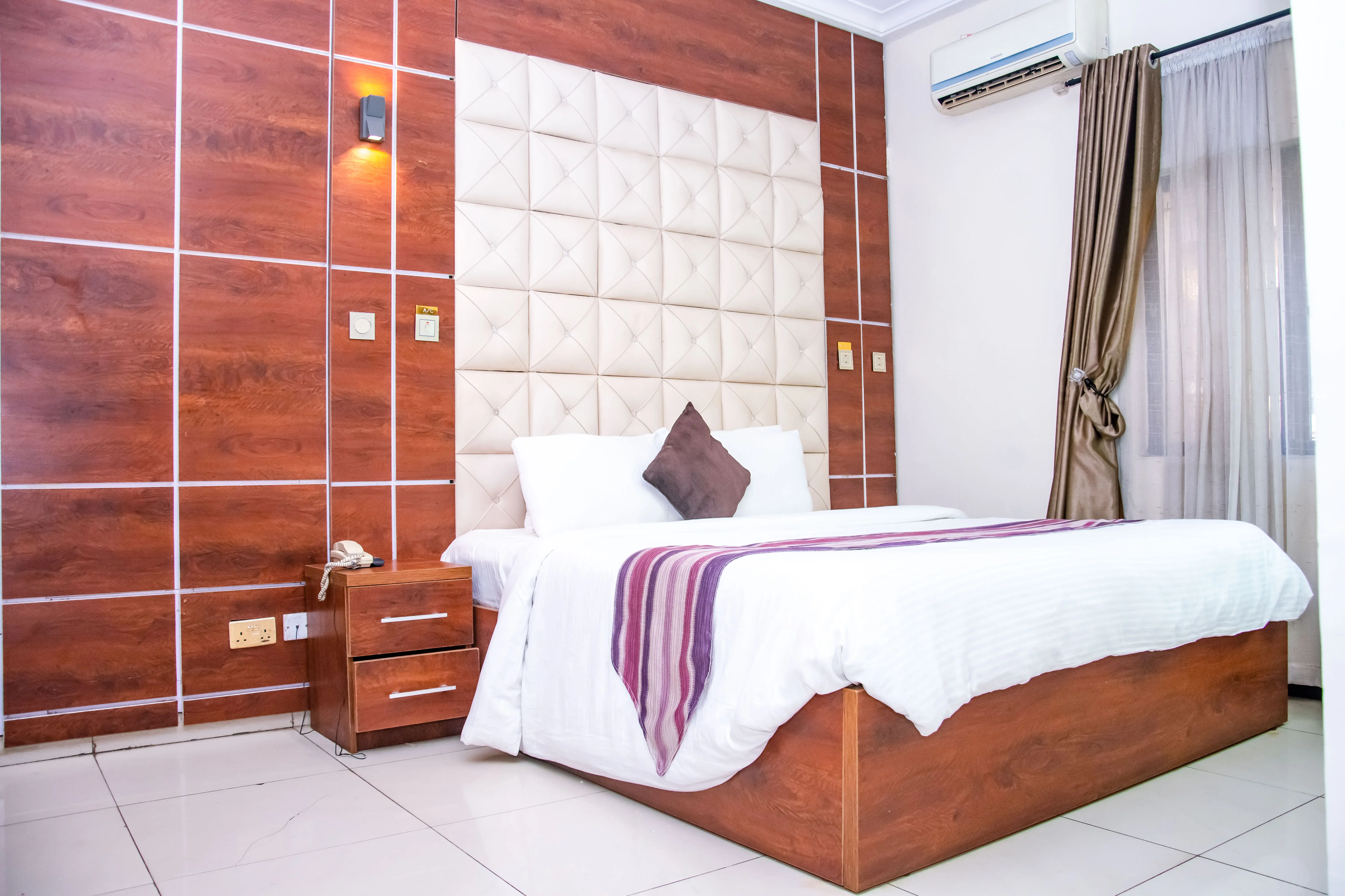 A bedroom with a large bed and a flat screen TV