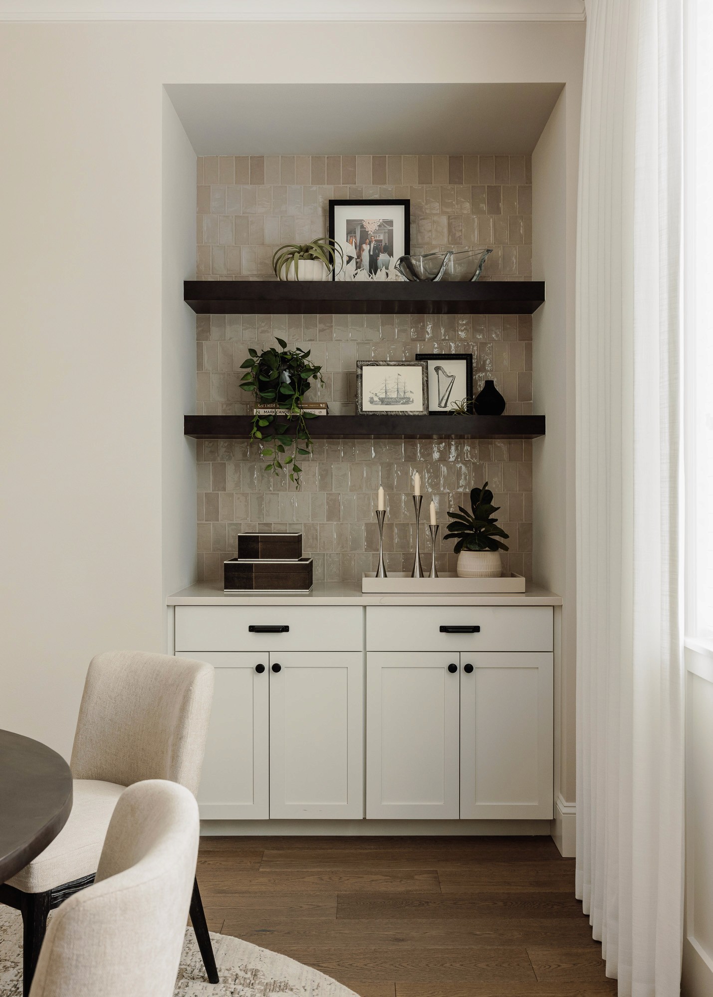 An organized storage nook in a clutter free dining room organized by Elegant Simplicity, a professional design and organizing firm in Bellevue Washington.