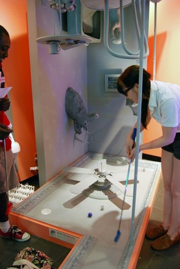 a woman interacting with the sculptures displayed on the exhibition