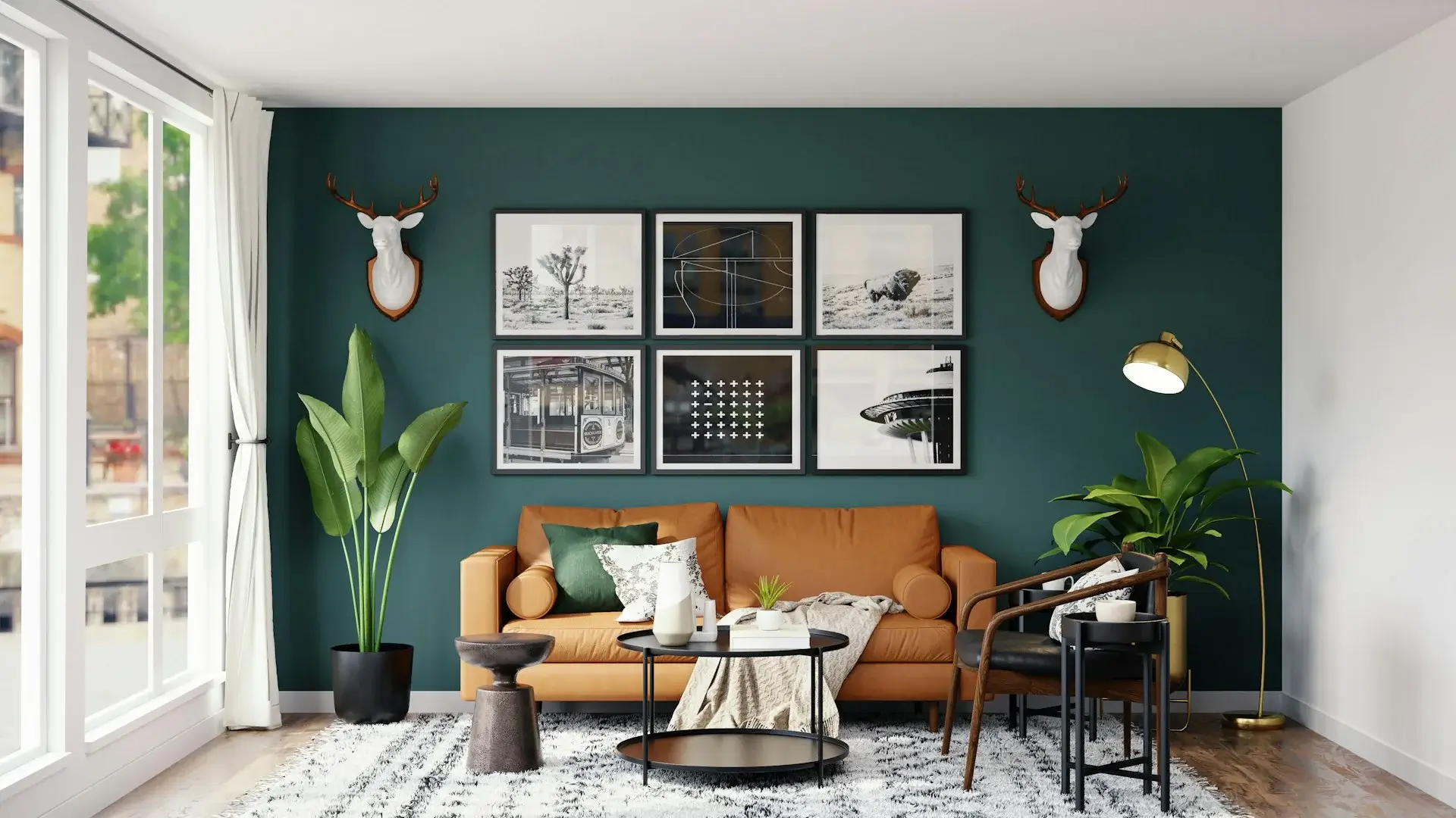 Stylish living room with green accent wall, leather sofa, framed art, and plants.