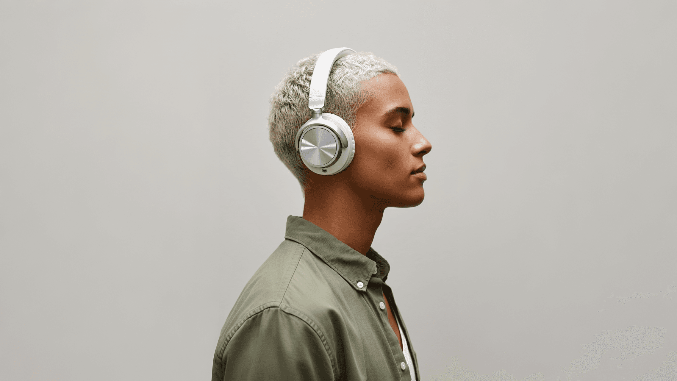 Man wearing silver headphones.