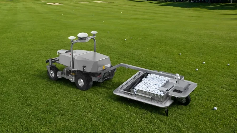 FJD RM21 Rough Ranger with a ball picking attachment collecting balls on a grass field