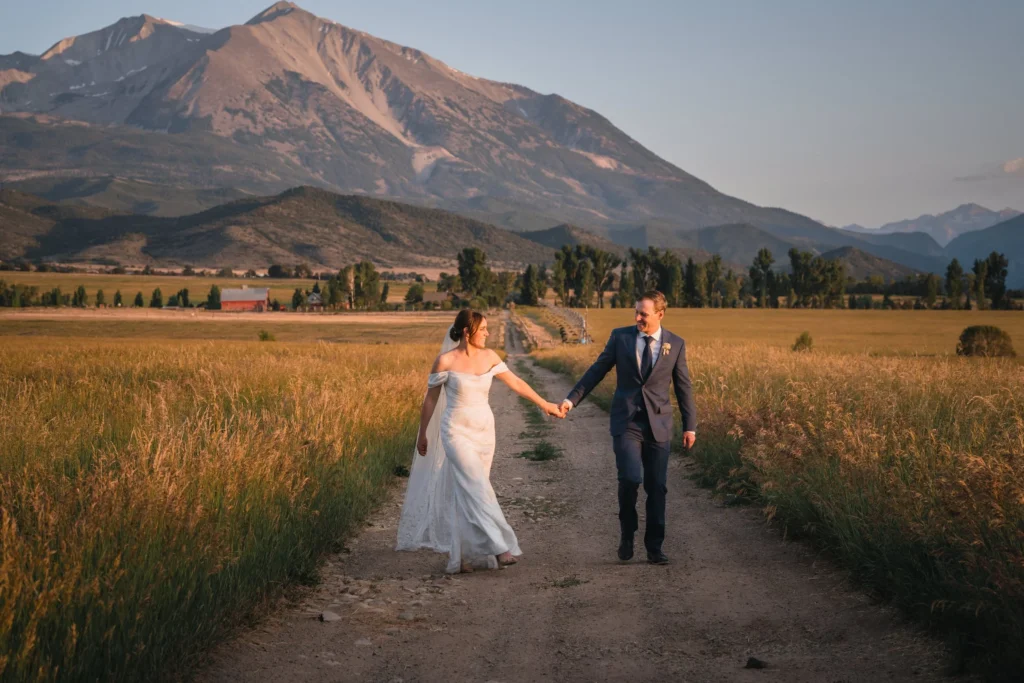 Newlyweds celebrating in open field at Carbondale Private Ranch Wedding