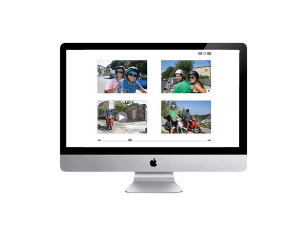 A silver Apple iMac computer monitor displays a photo gallery on its screen. The gallery contains four photos arranged in a 2x2 grid: two images show people, one shows a play button, and the other depicts two people on motorcycles. The monitor has a thin black bezel and a silver base. The Apple logo is visible at the bottom center of the screen.