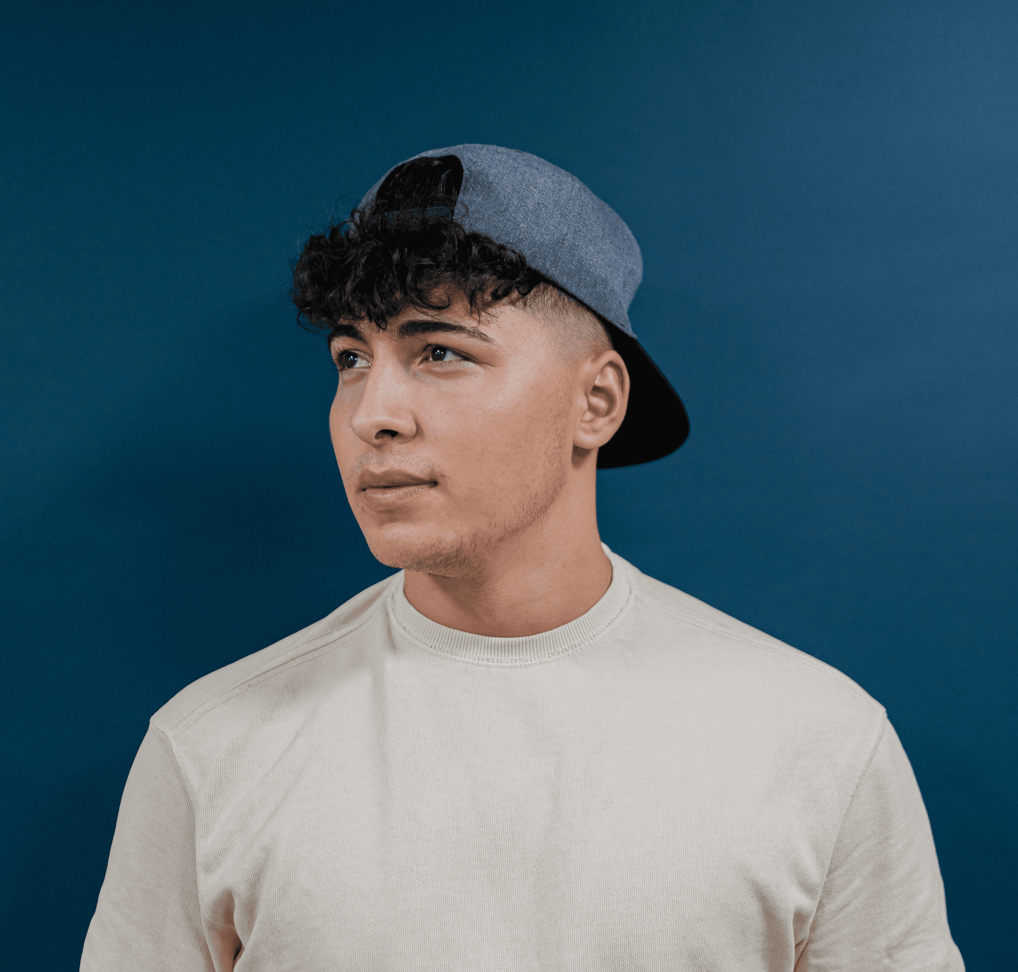 a young man wearing a hat and a t - shirt