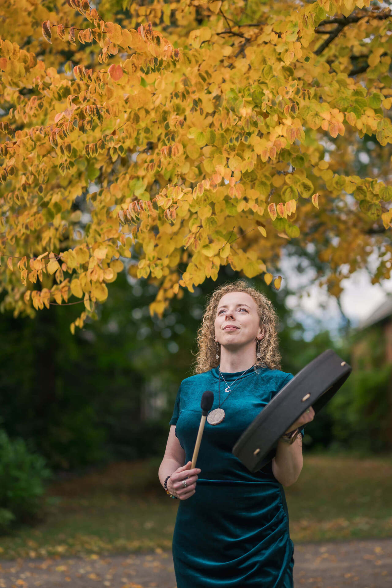 Maryrose playing the drum looking up into the sky
