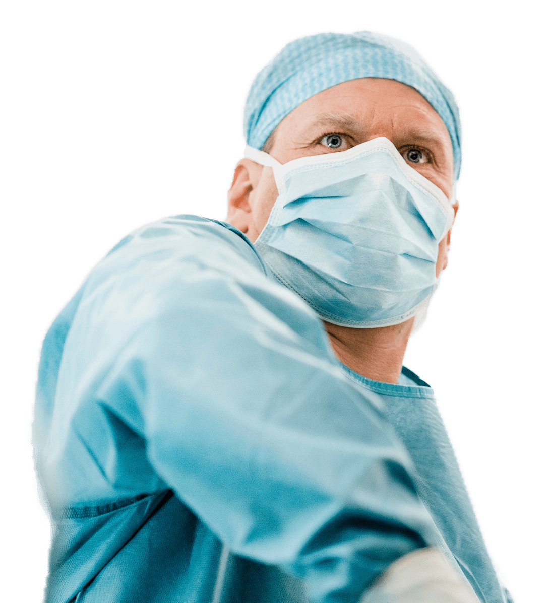 A person in medical attire looking at camera and standing with arms crossed