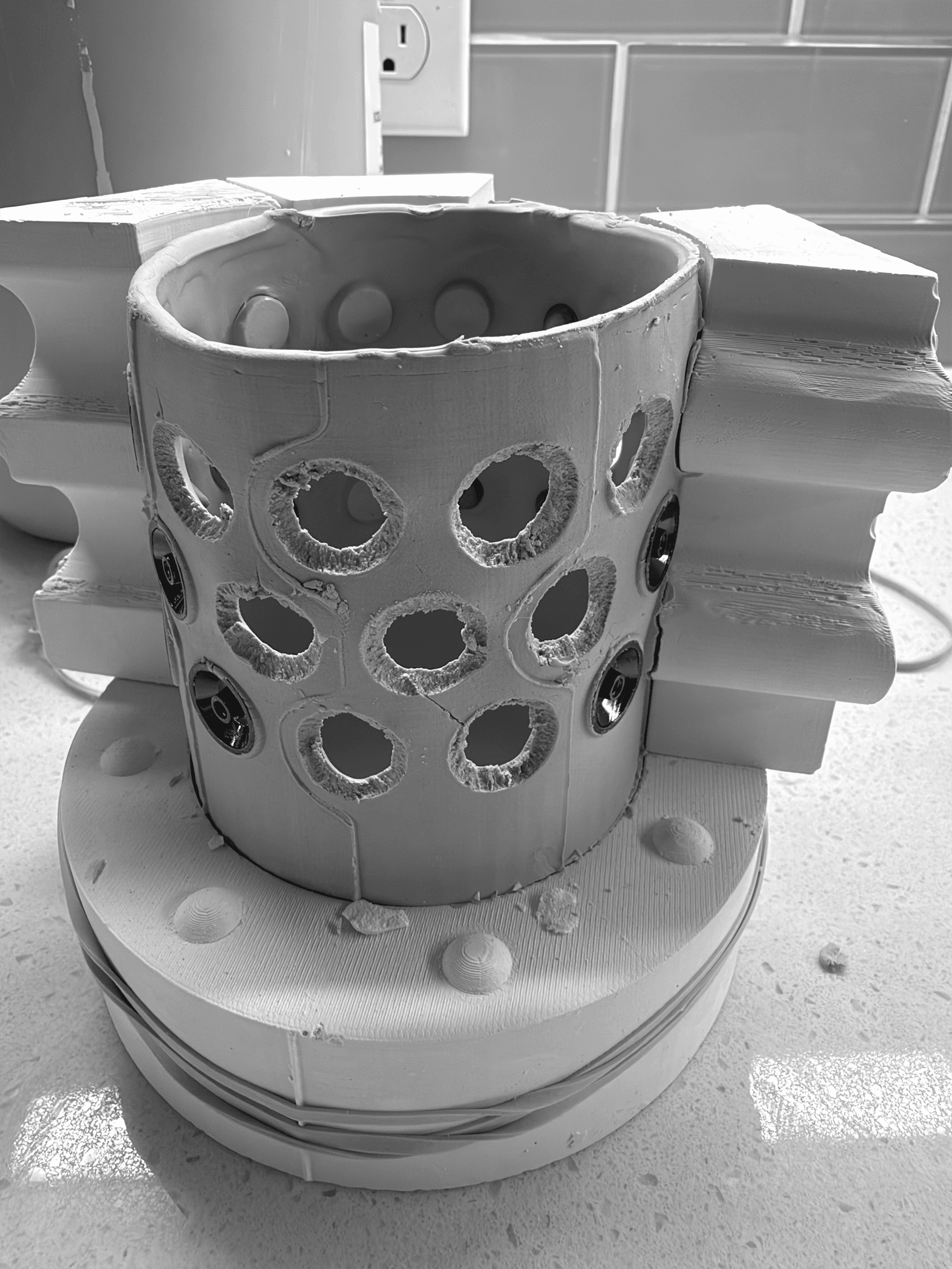 Batch.Works logo over a photo of a box of 3D printed objects