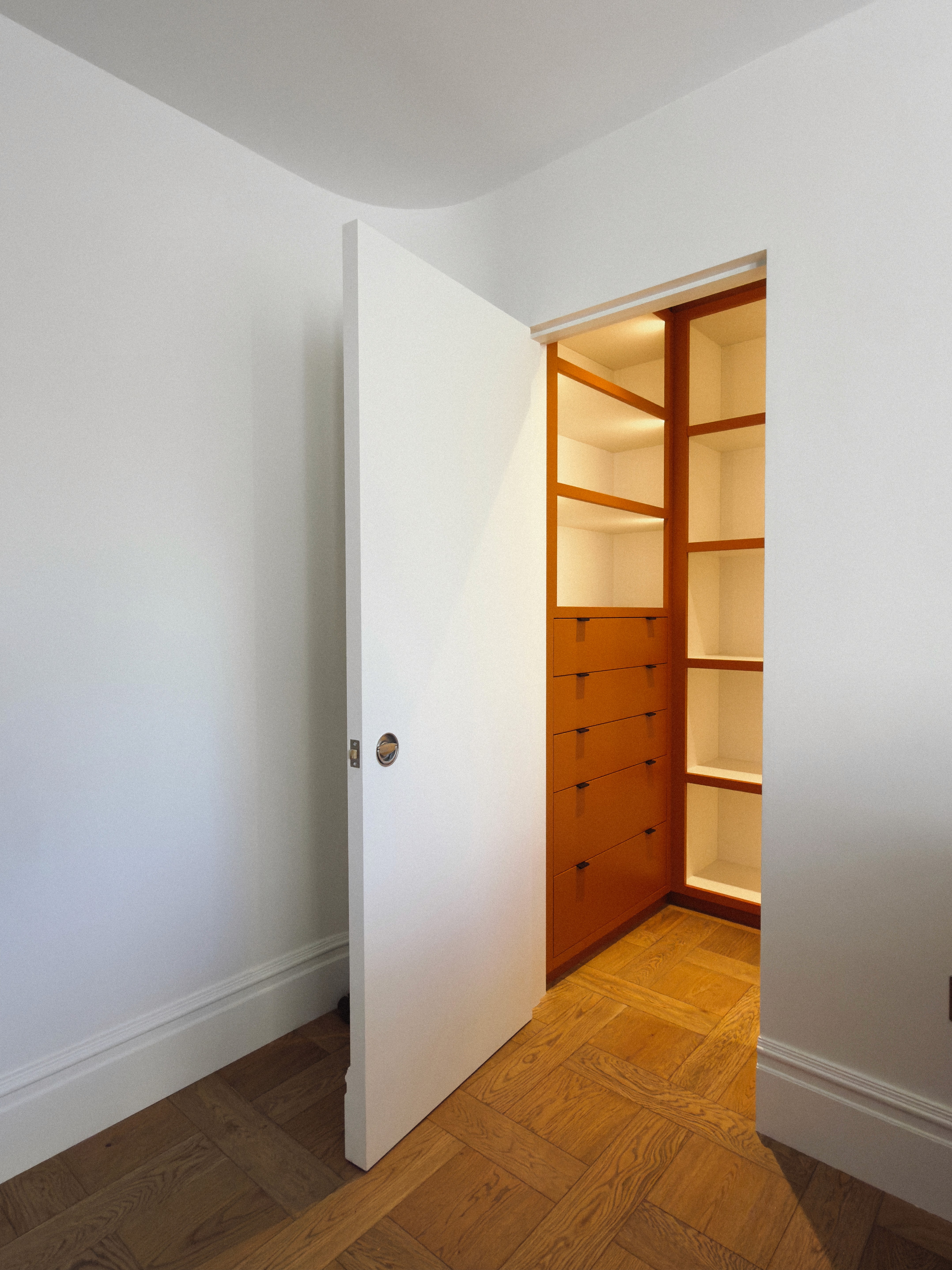Orange lacquer walkin wardrobe with led lighting