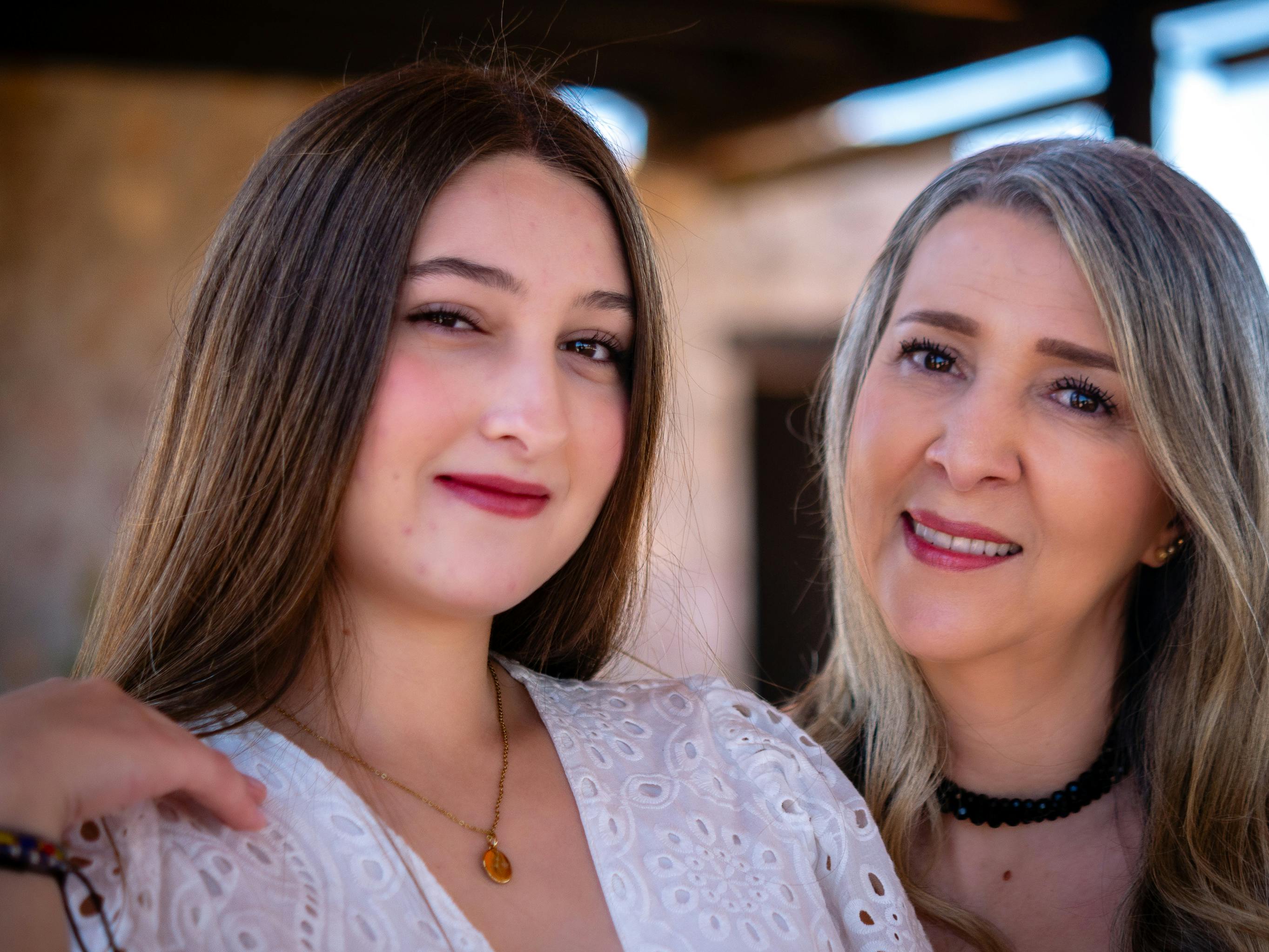 Conversion Truth for Families: Teenage daughter and mother posing for a photo together outdoors