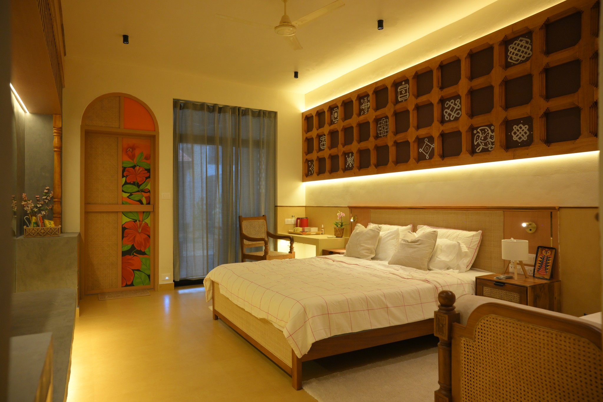 A luxurious indoor pool area with a panoramic view of a city at sunset. Comfortable lounge beds with soft fabrics surround the pool, while warm ambient lighting enhances the sophisticated atmosphere. The space combines modern elegance with a tranquil vibe.