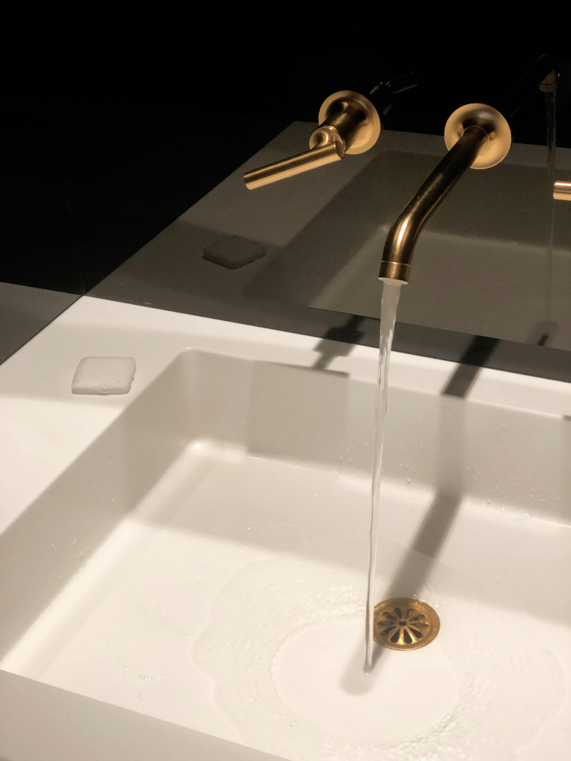 white sink gold faucet