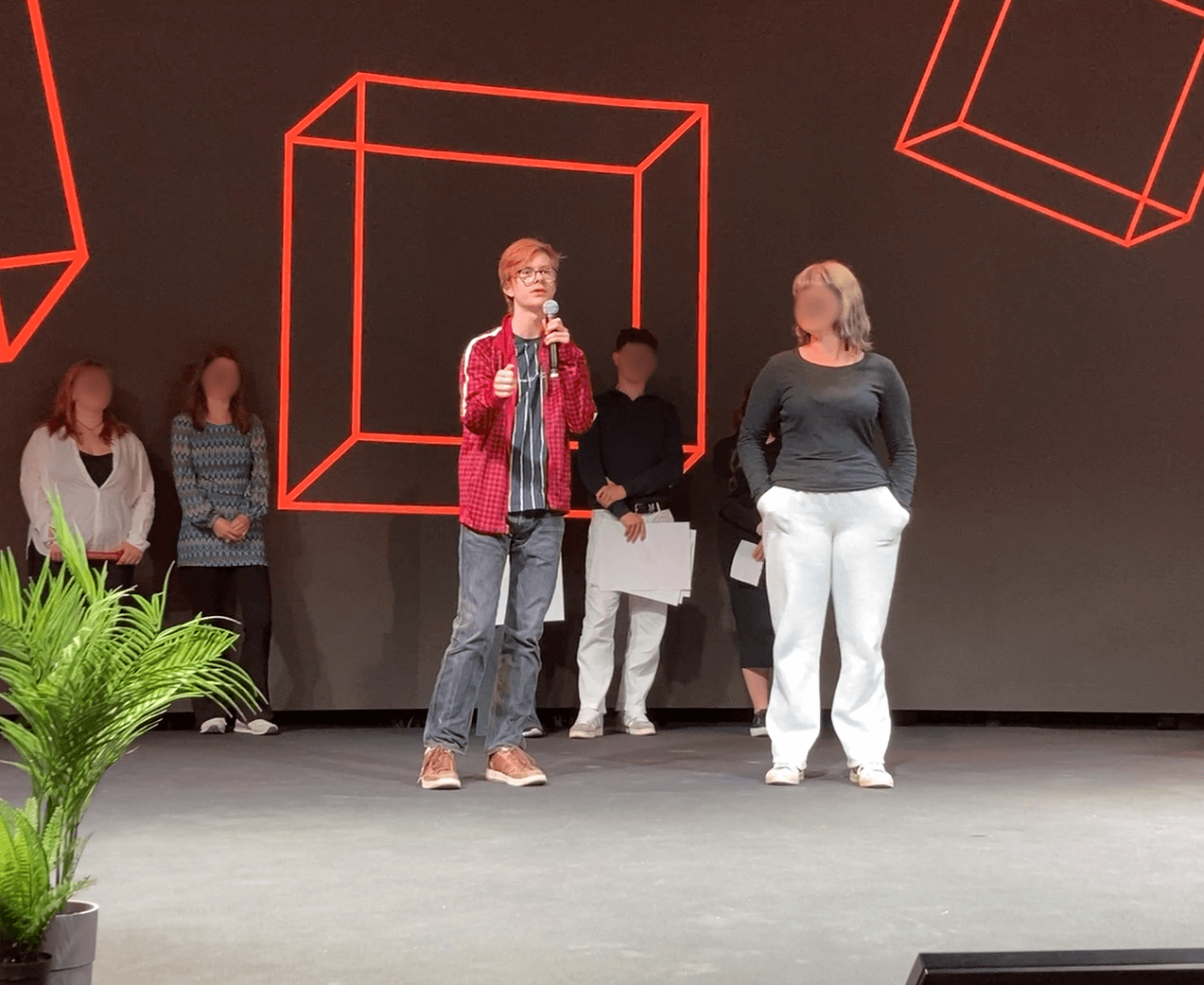 Junior on the stage giving his speech to an audience