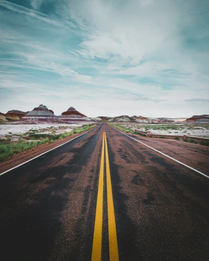 Straight desert highway representing long-haul trucking travel and safety awareness