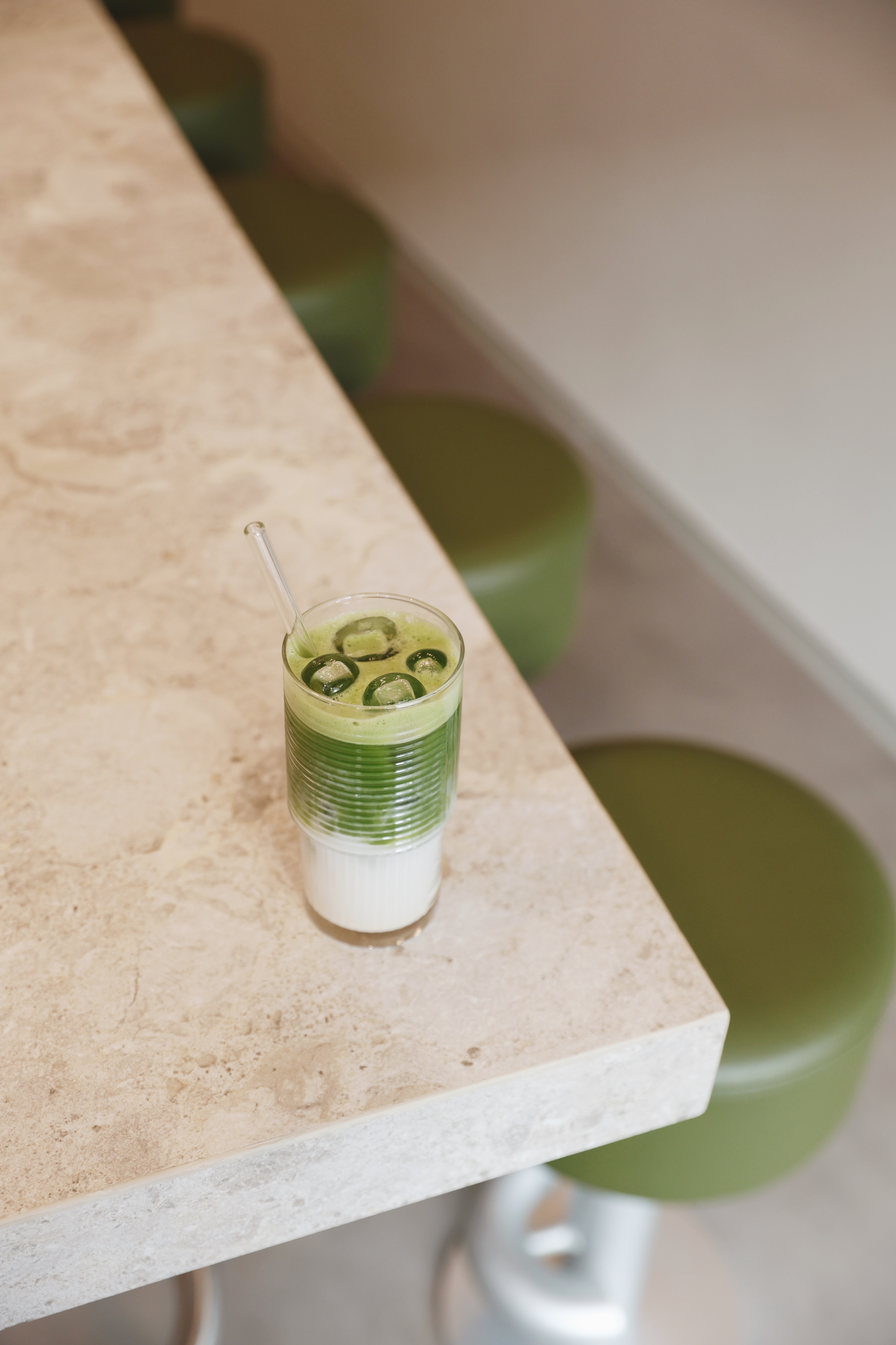 Iced matcha latte with milk served on a marble counter at Jo & The Sisters Morning Club.
