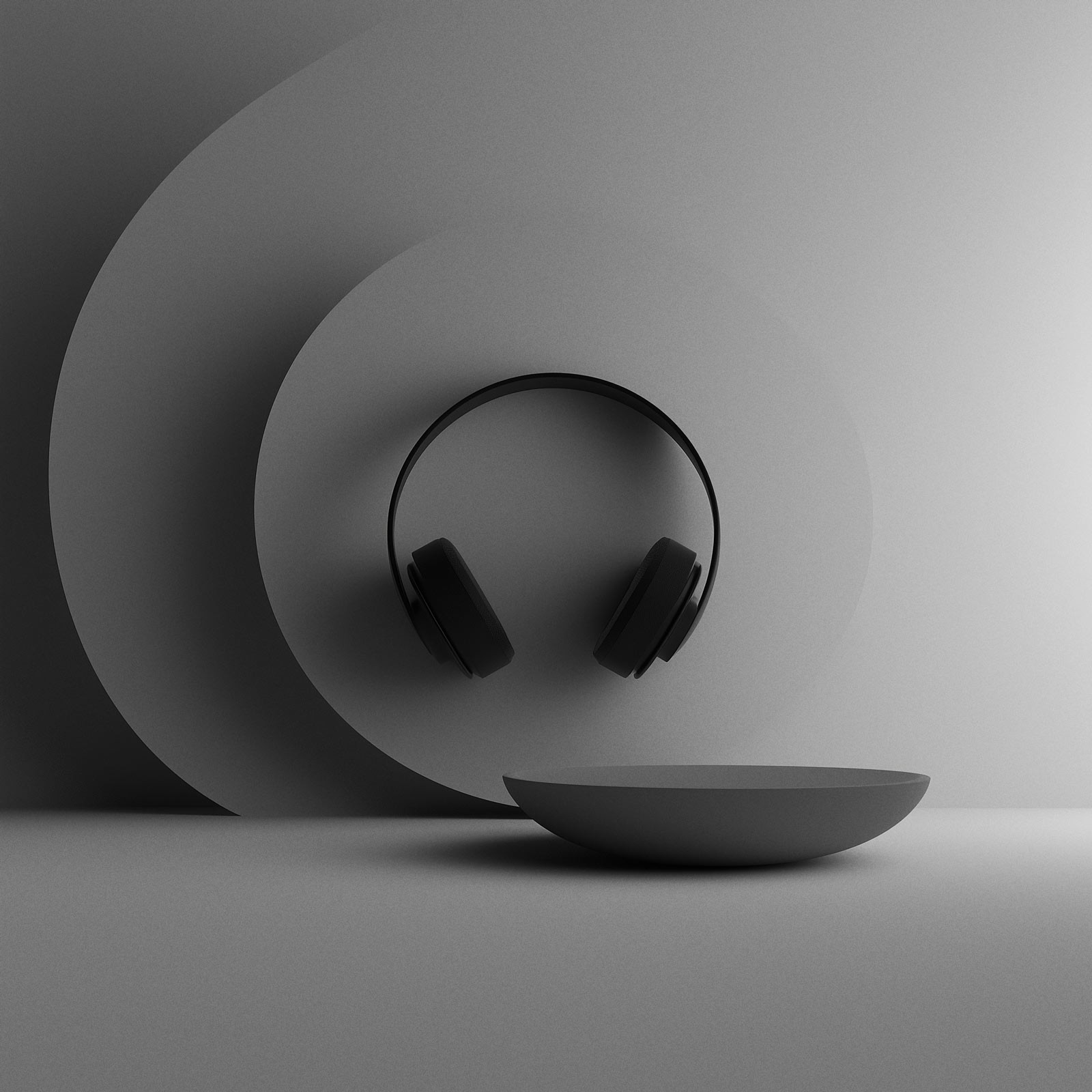 Sphere resting in shallow bowl, soft gray tones