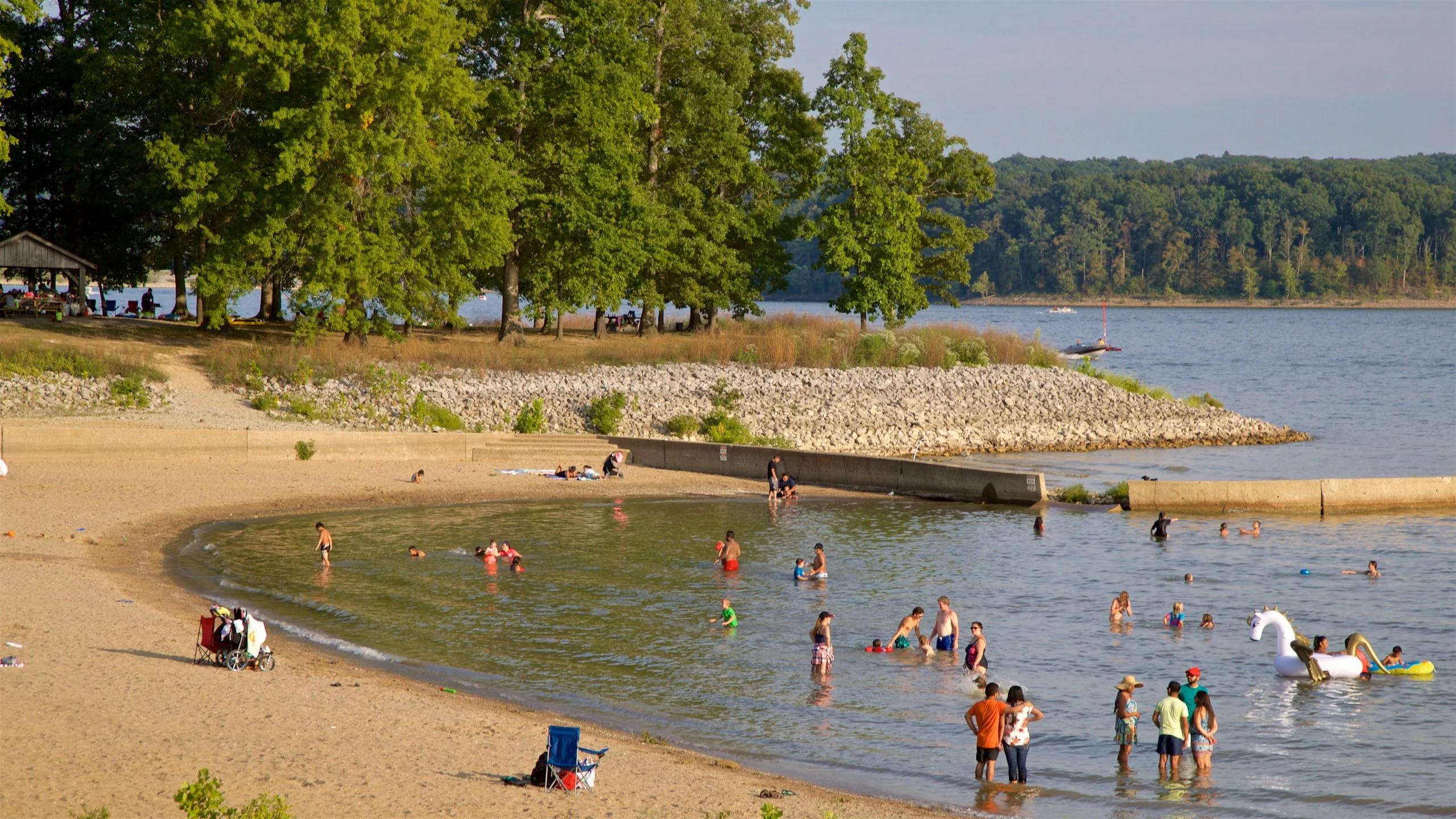 Aerial view of an intersecting dirt pathway forming an X-shape surrounded by lush greenery and arid, rocky terrain, illustrating a contrasting landscape.