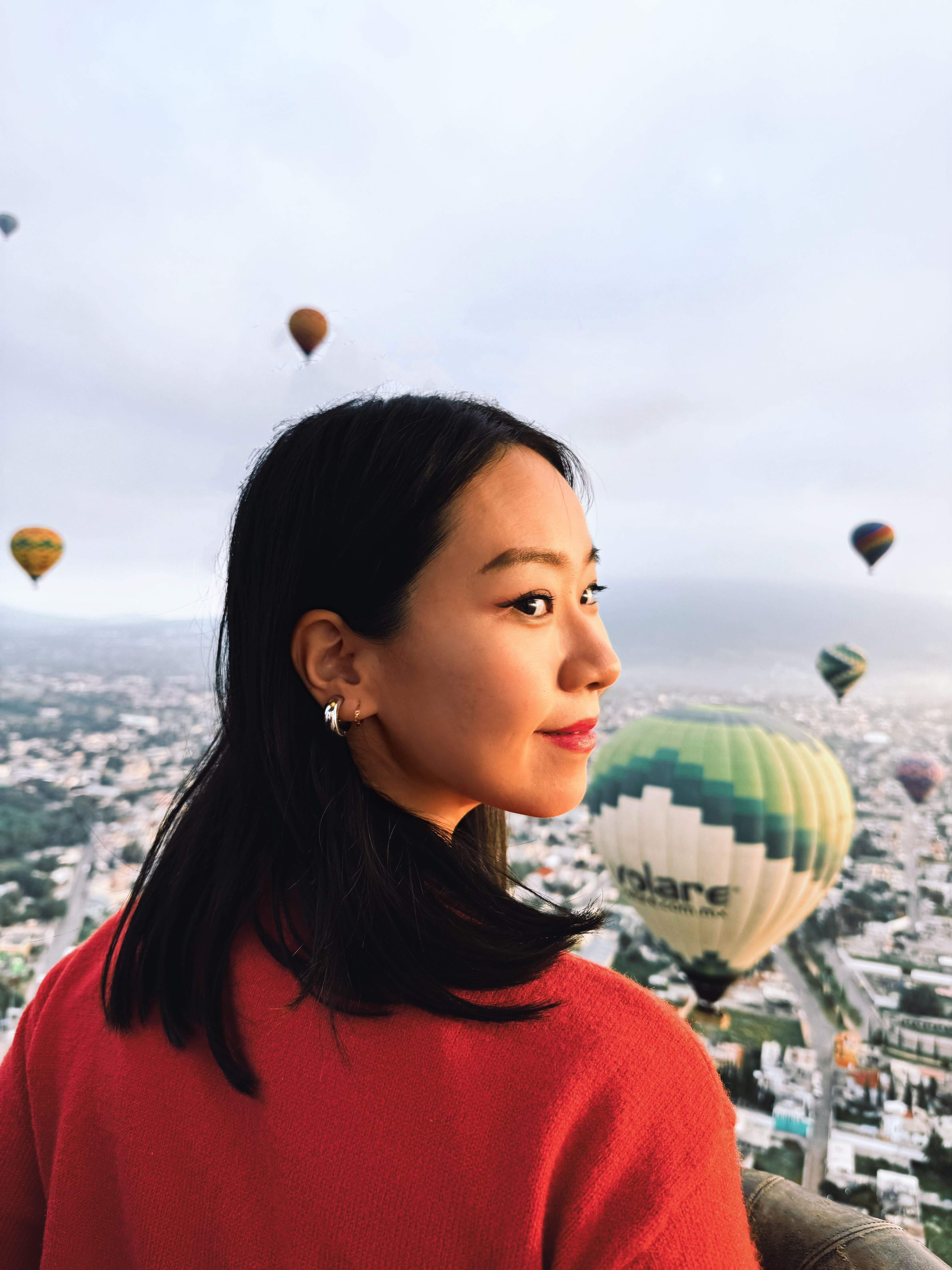 Portrait of man looking to the left and smiling with a dark background