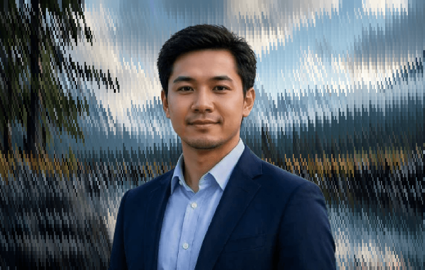 Professional portrait of an engineering leader in formal attire against a scenic background.