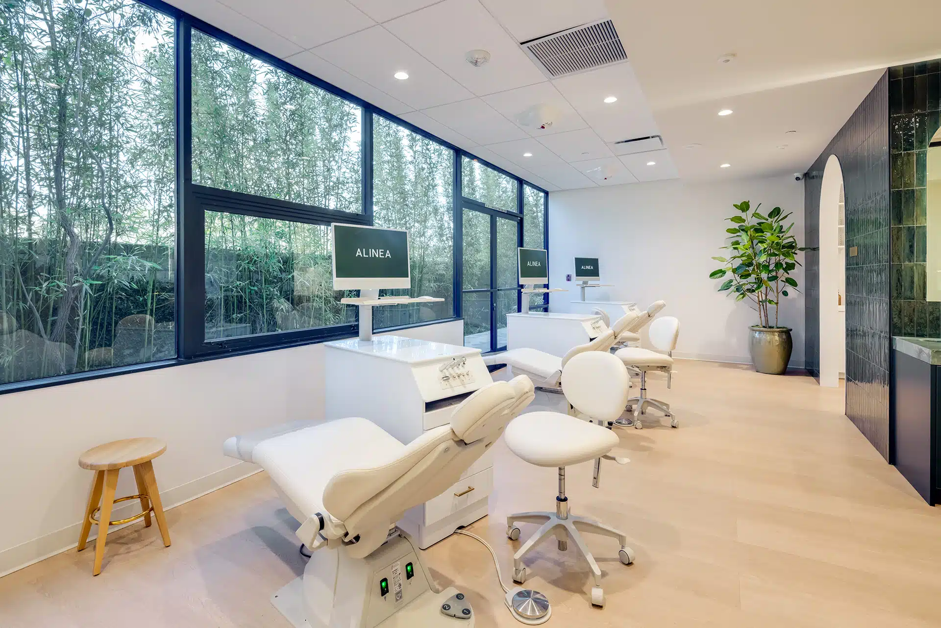 Bright orthodontic treatment space with dental chairs and large windows at Alinea Orthodontics clinic.