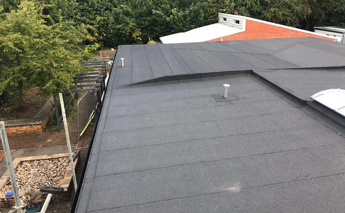 Construction workers building a wooden frame for a new barndominium, showcasing the early stages of rural home construction with sturdy timber beams in a sunny countryside setting.