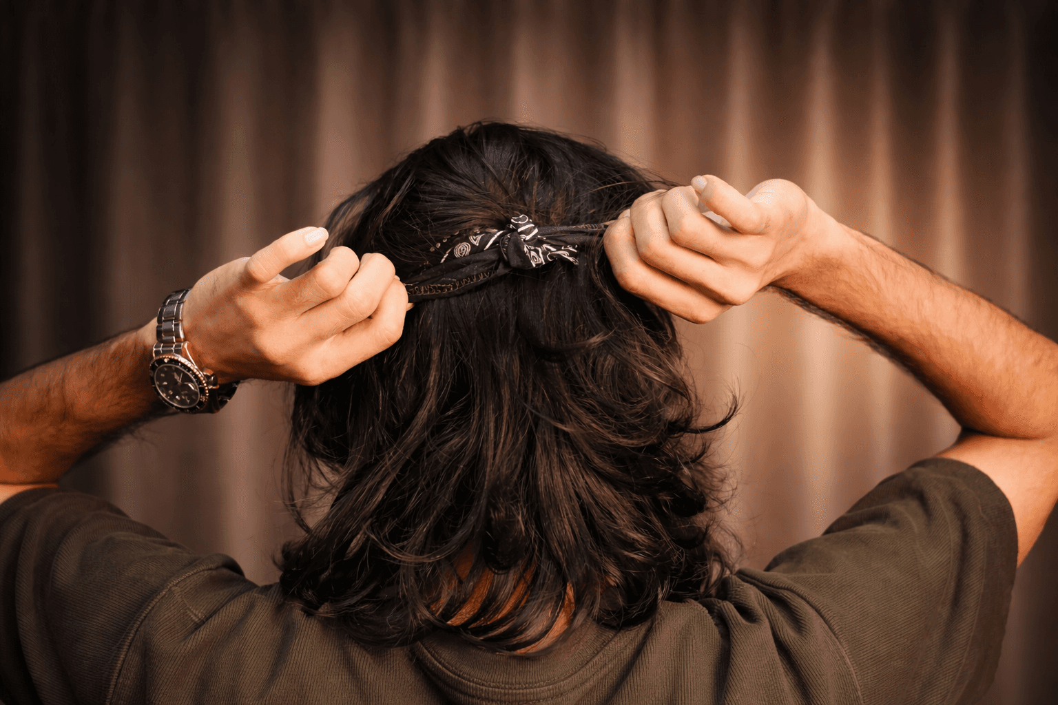 Four friends in winter streetwear laughing in an underpass