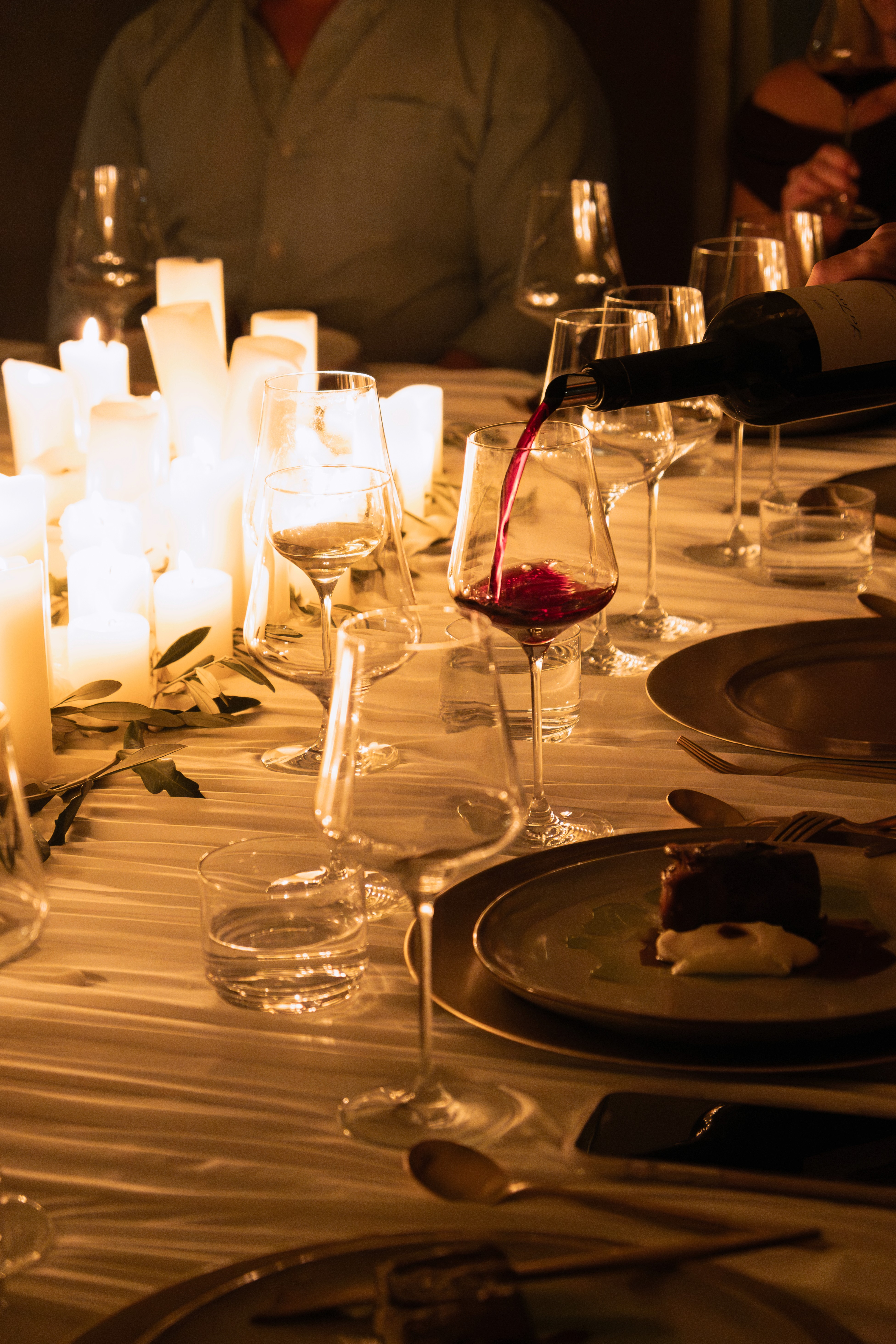 Candlelight wine dinner with red wine flowing.
