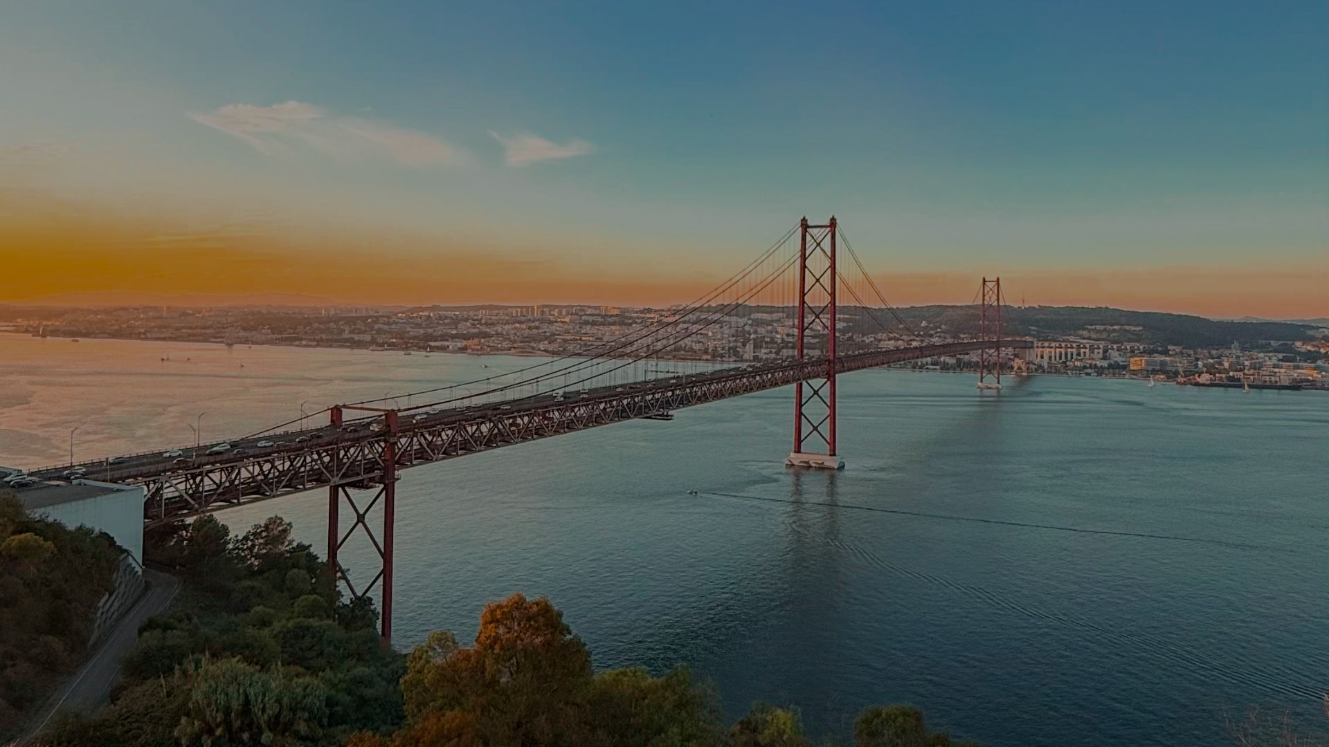 two people sitting on a bench looking at a mountain