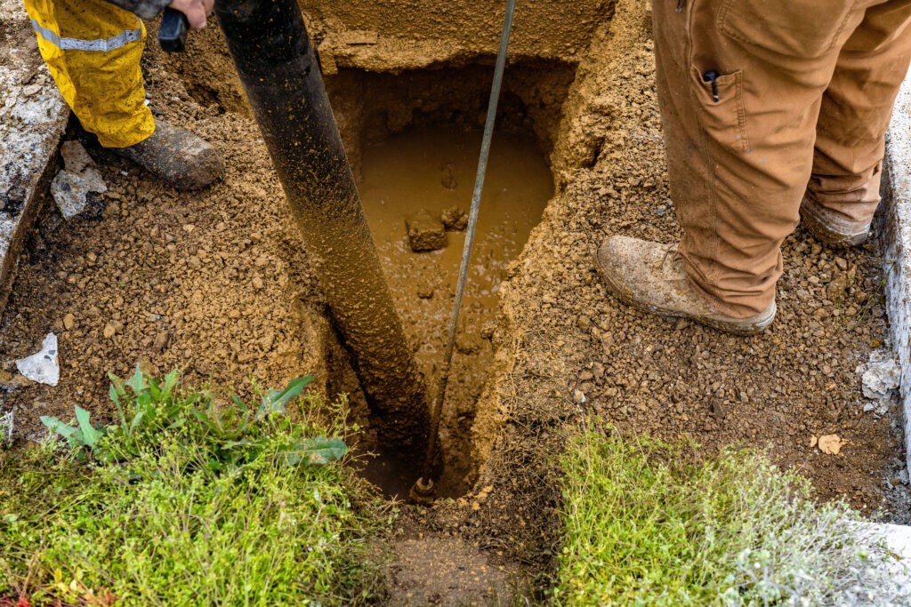 trenching through mud for hydro lines