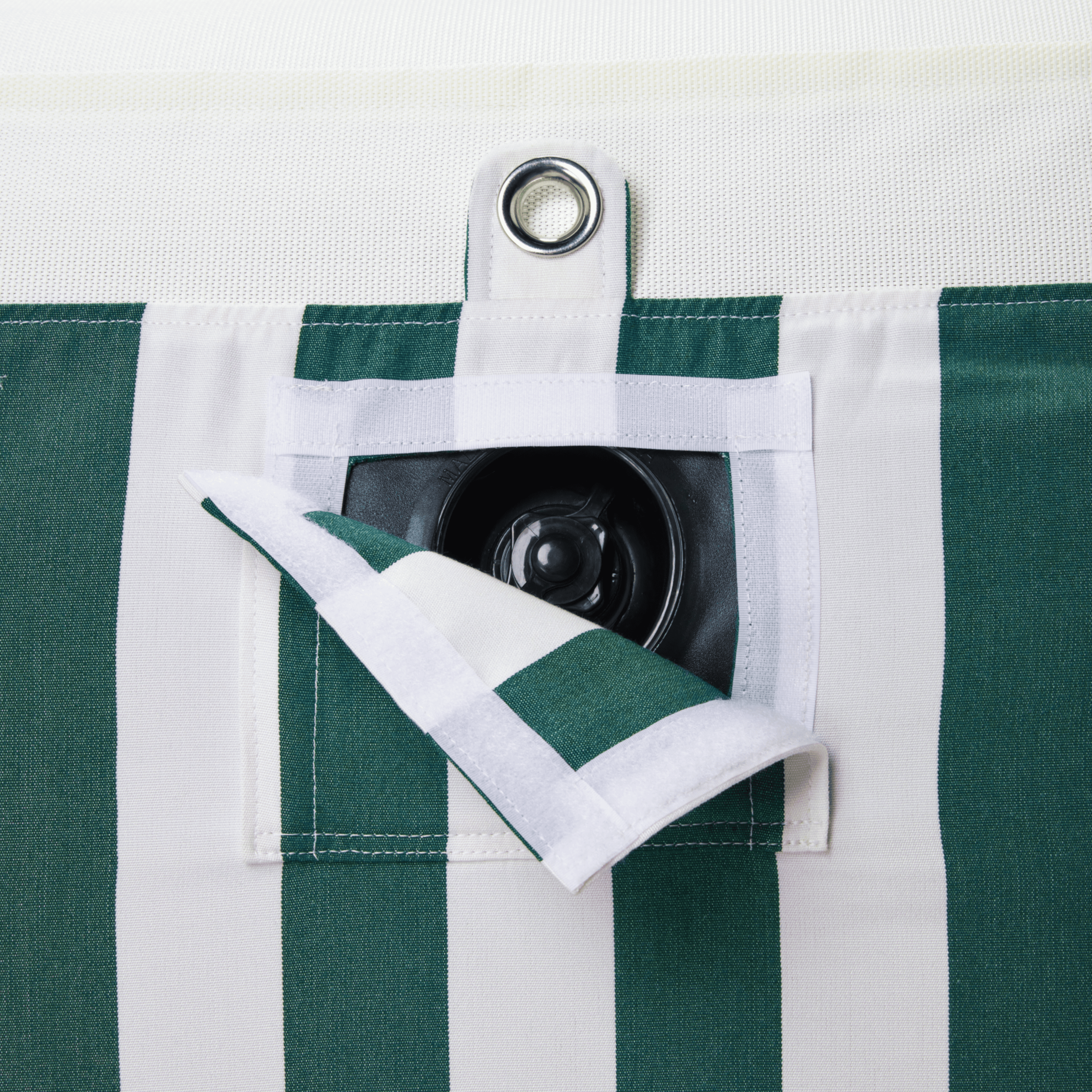 Close-up of pool float showing green-and-white canvas, inflation valve, and matte white zipper