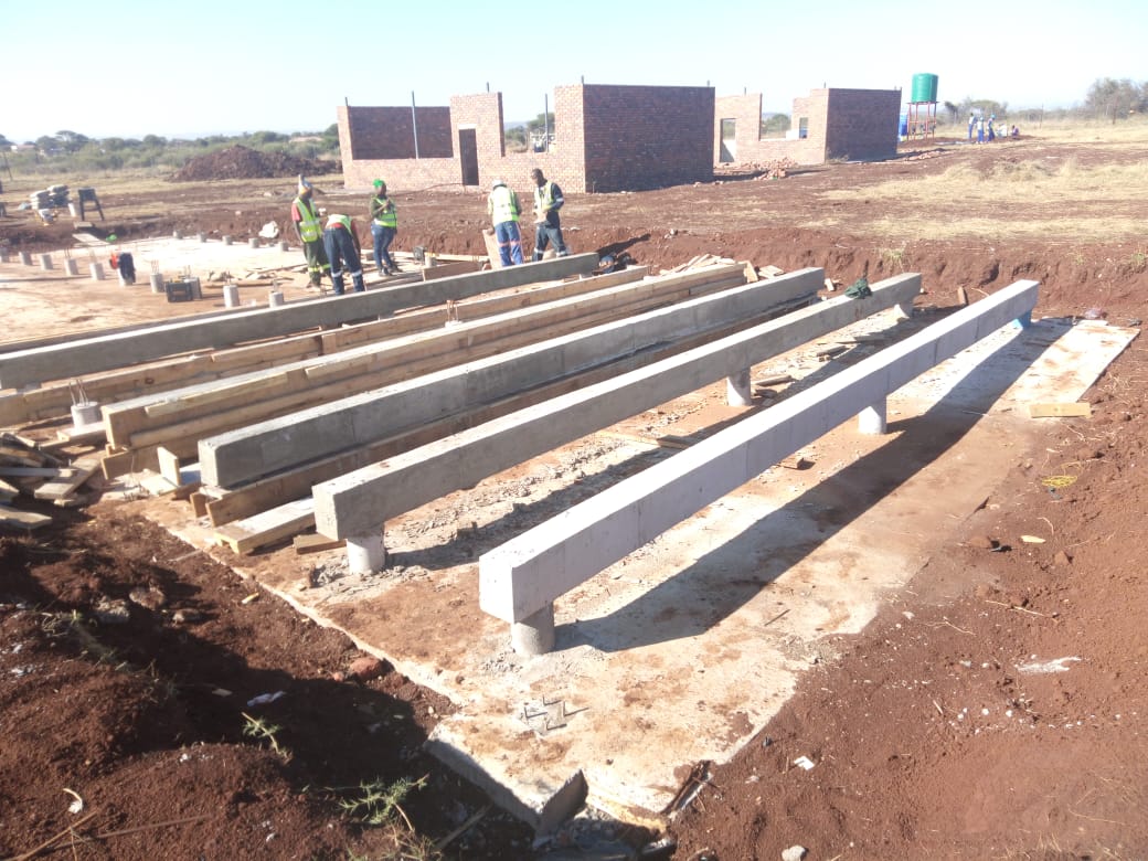 Concrete foundation elements and columns under construction.