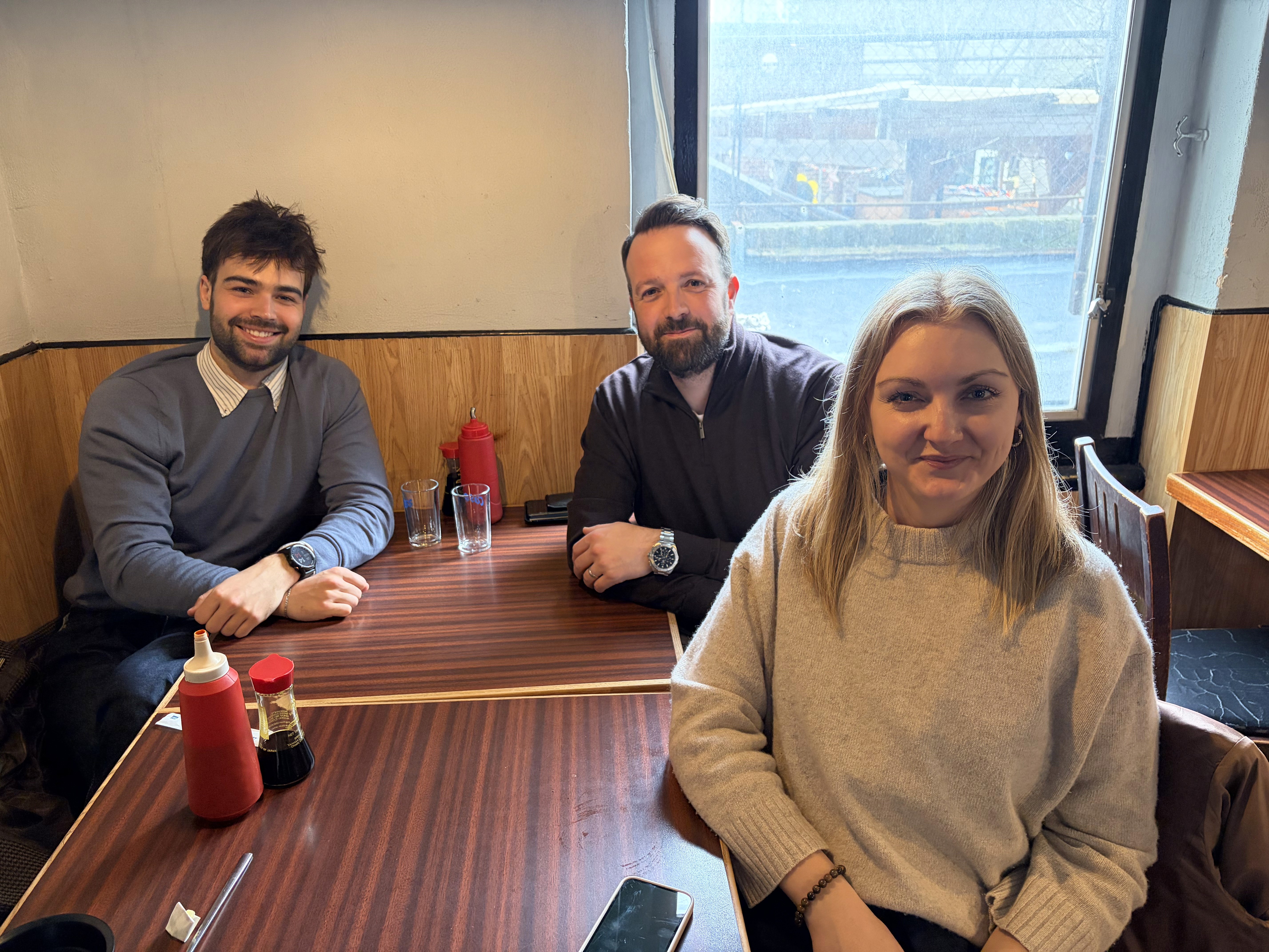 four people around a desk