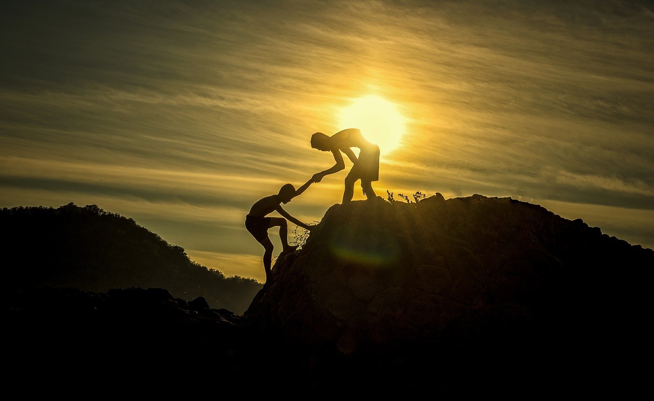 Climbers helping each other