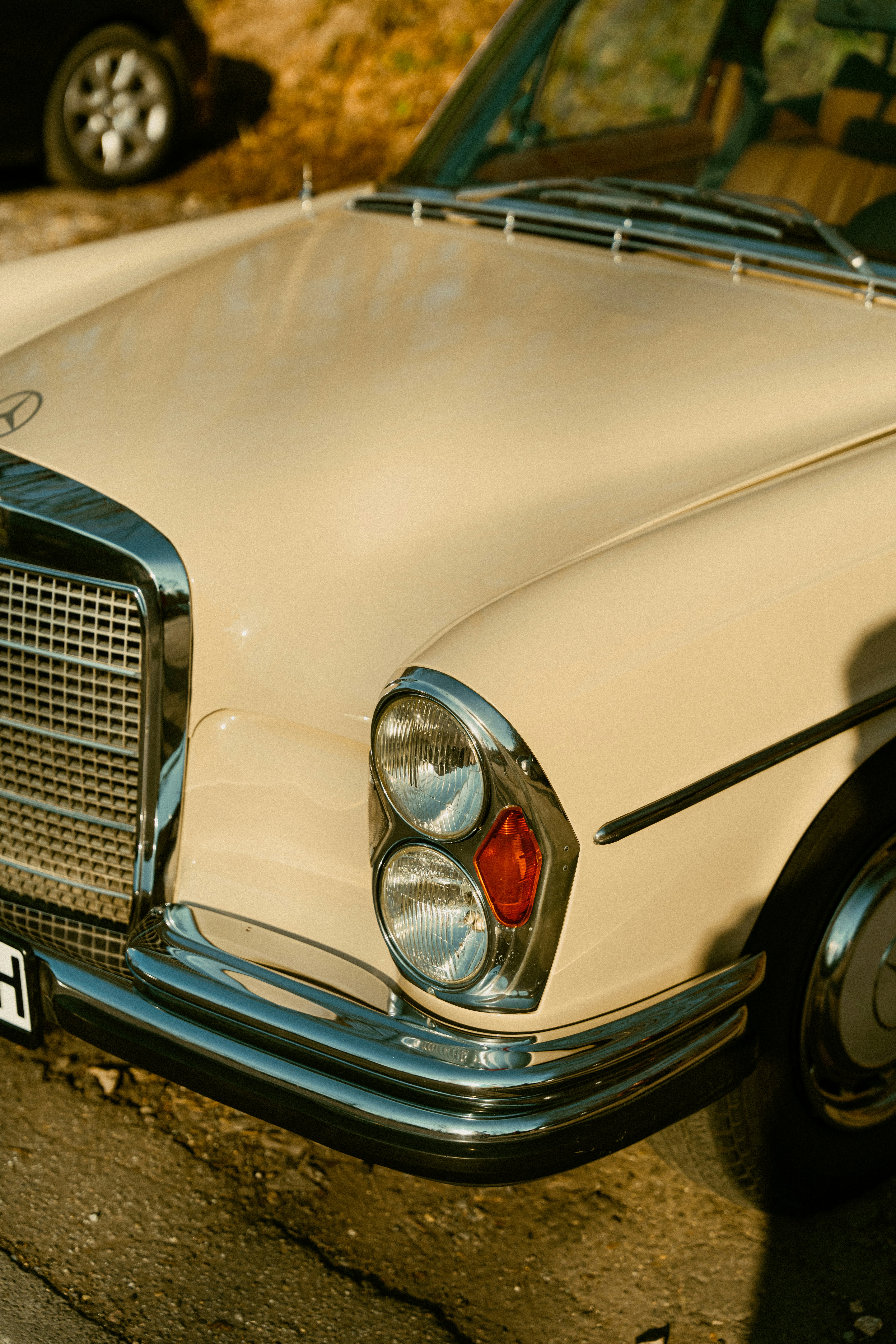 Close-up of a vintage cream-colored car front.